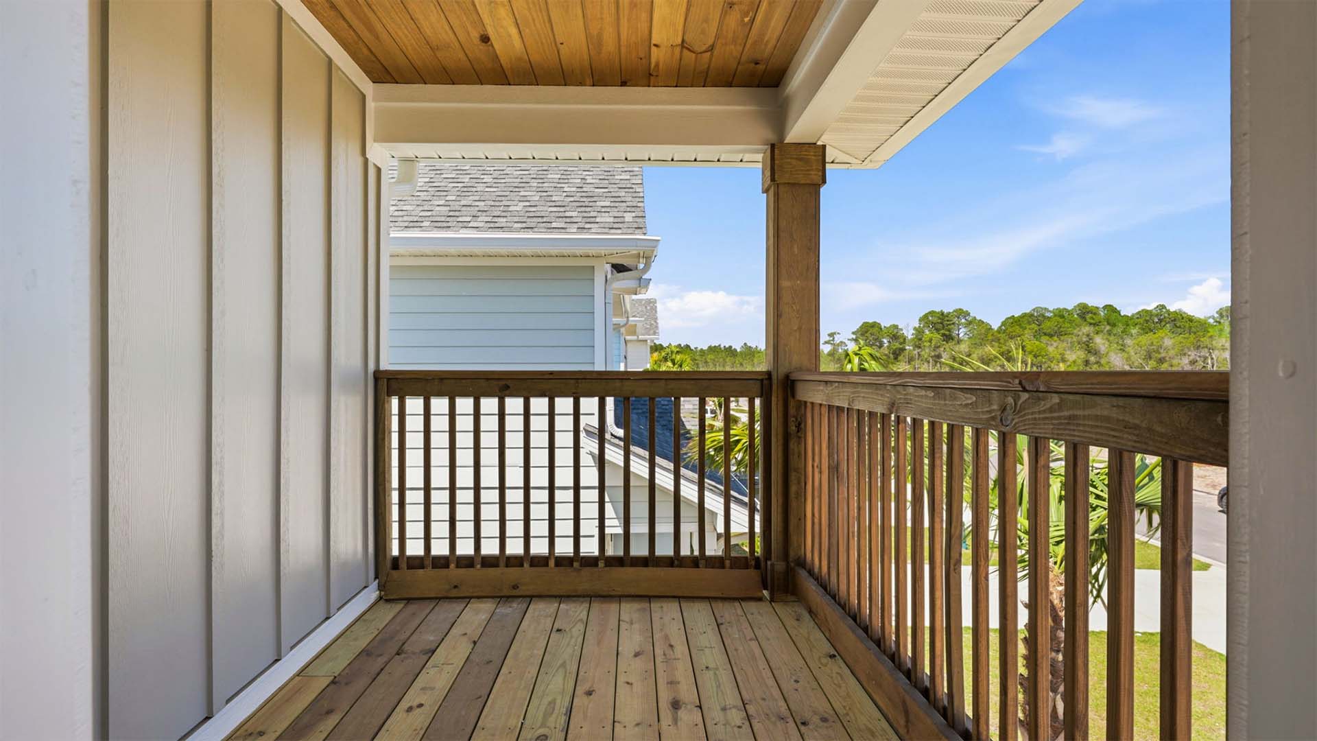 The private balcony off the primary bedroom overlooks the front of the home