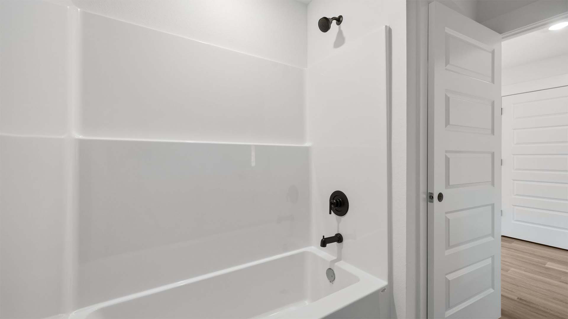 The shared bathroom has a shower tub combination