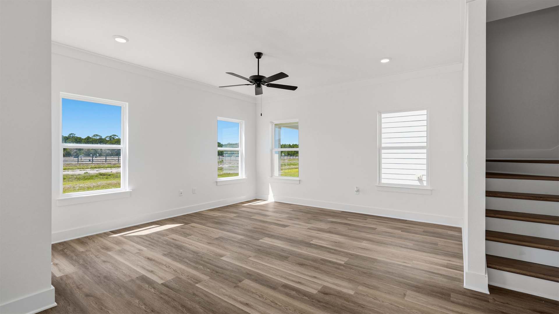 The living area is open and has a ceiling fan overhead