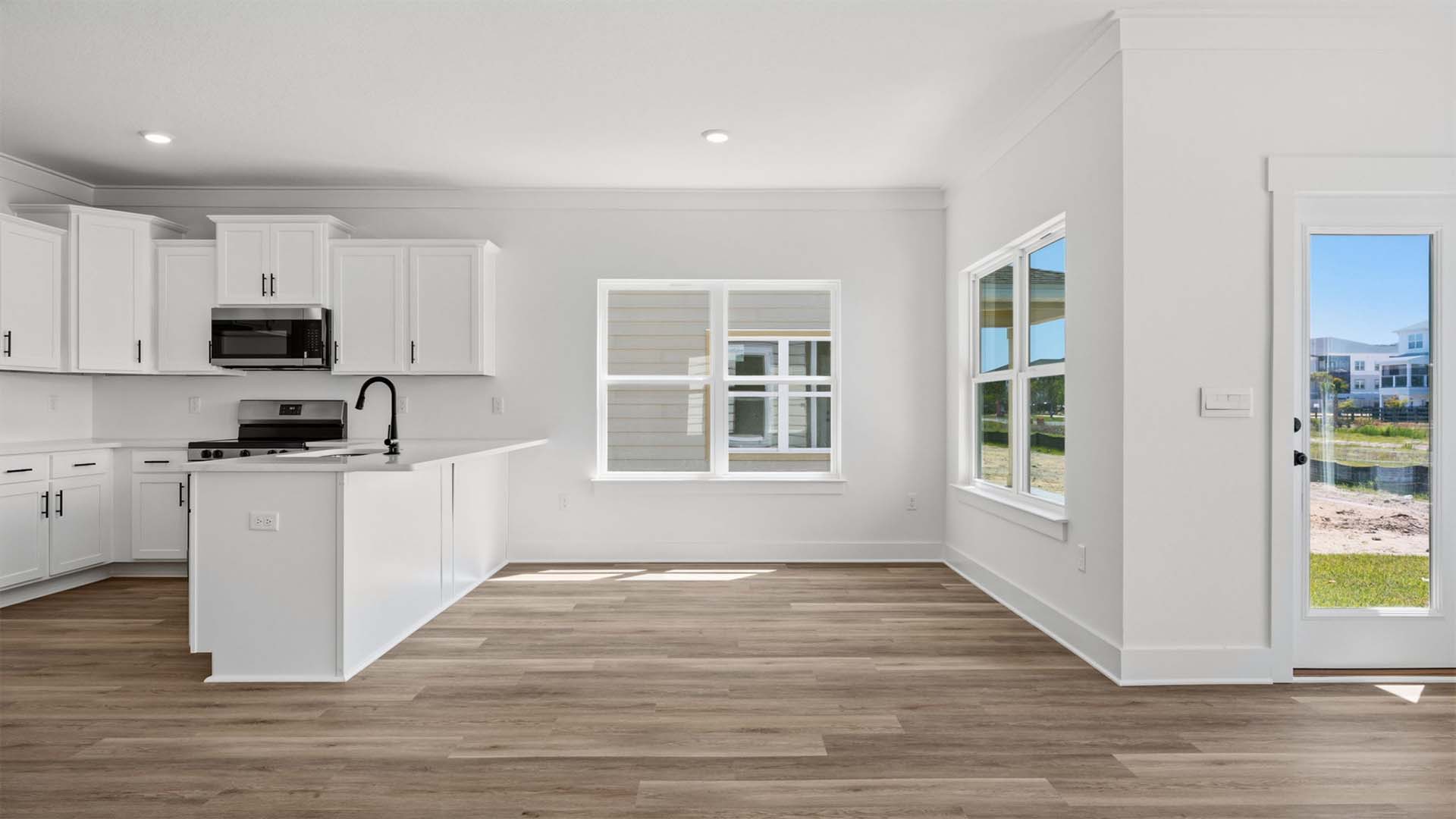 The dining area is surrounded by windows for natural light