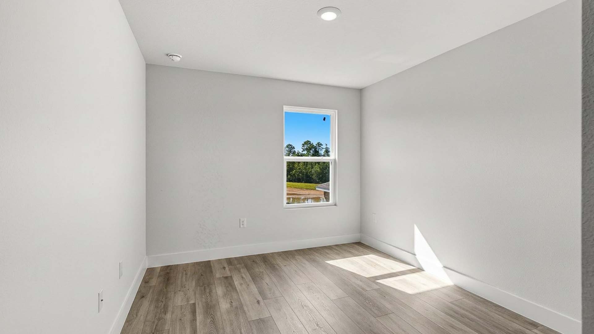 Guest bedroom two has EVP flooring and ample closet space