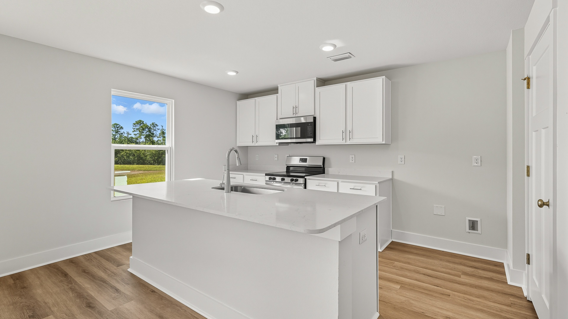 Kitchen with white cabinetry that complements the quartz countertops