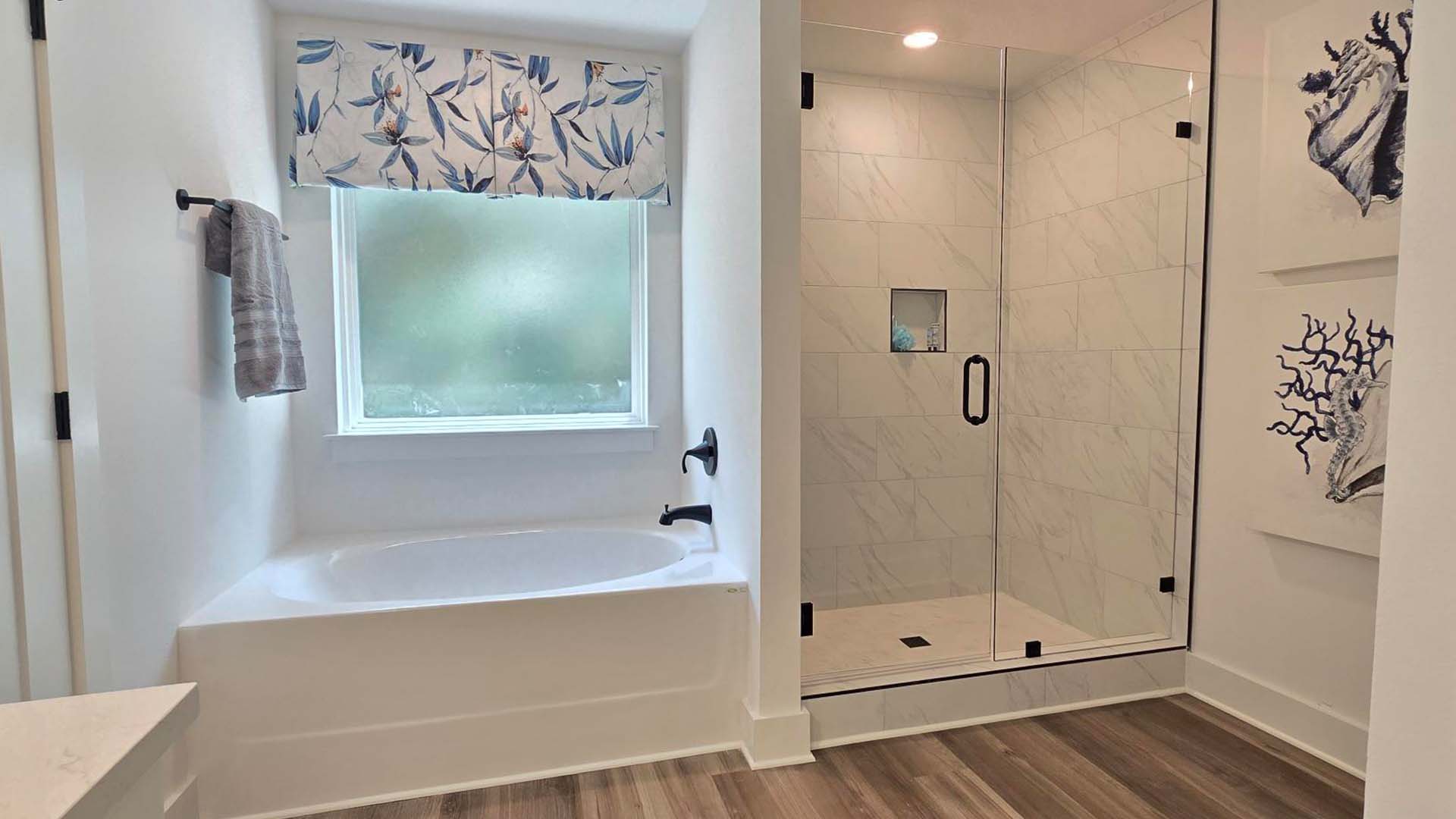 The primary bedroom is located on the second level and has a separate shower and soak tub