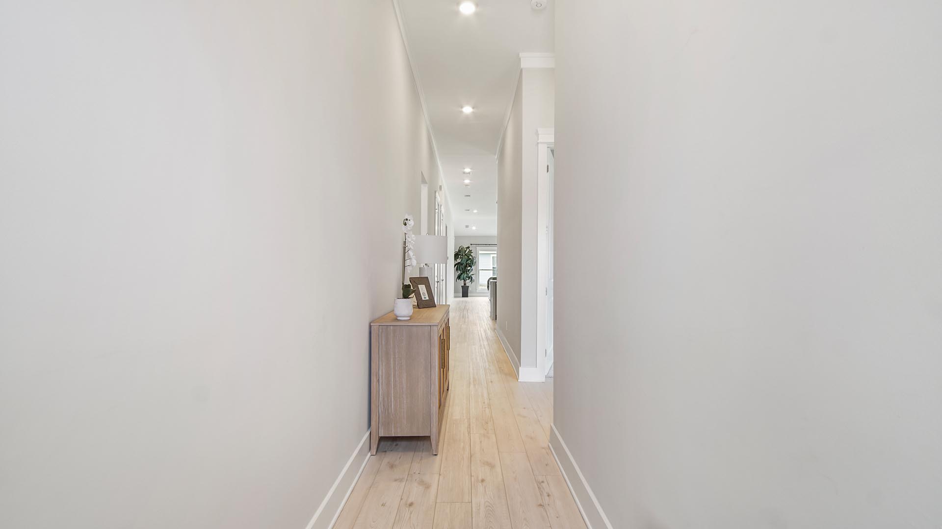 Foyer with EVP flooring and hallways to guest bedrooms and mudroom and laundry room and opens up to living area.