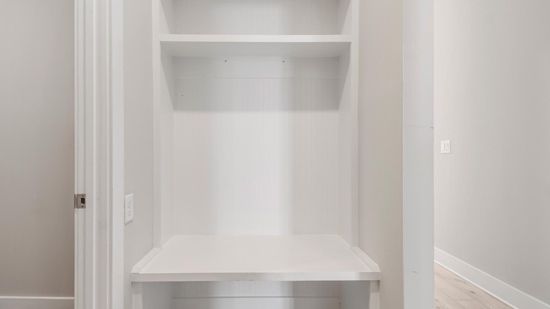 Mudroom with wood shelving.