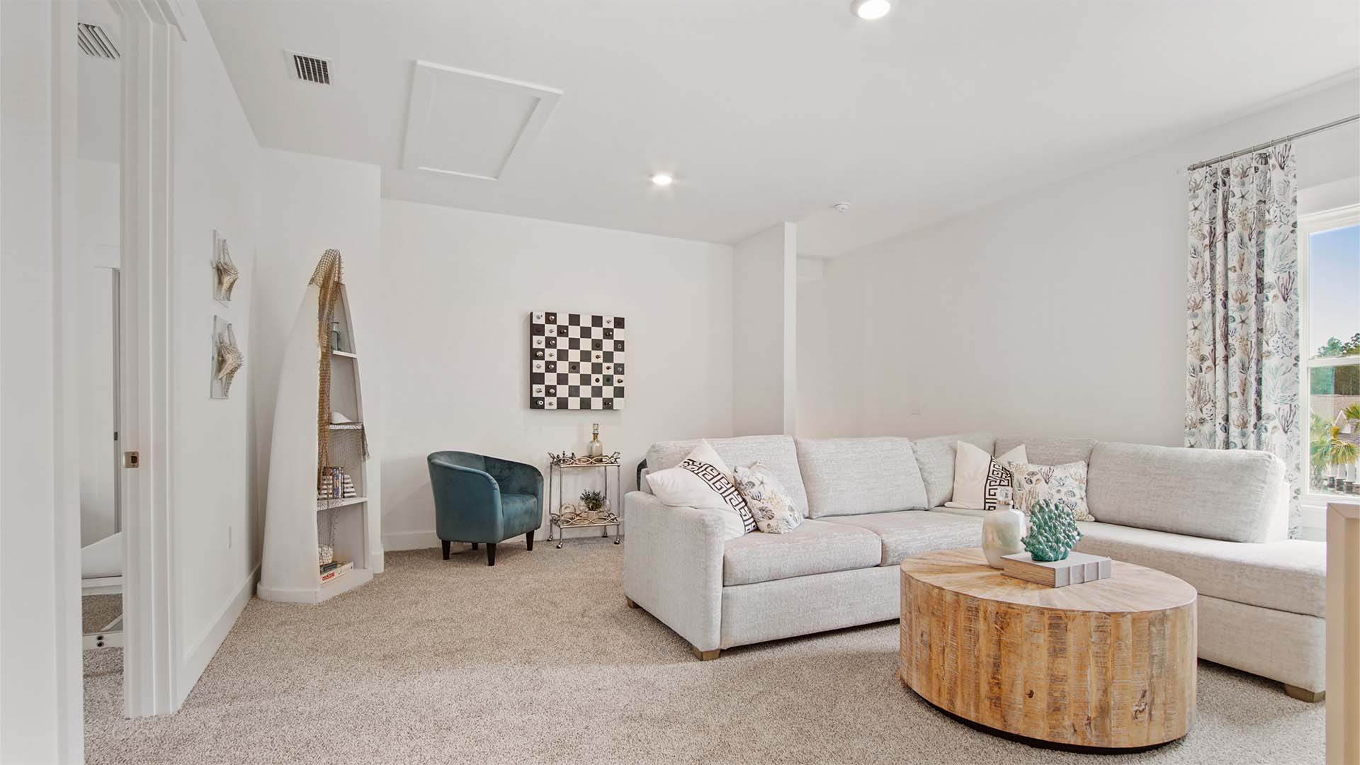 Upstairs family room with carpet flooring and a window and next to a guest bedroom door.