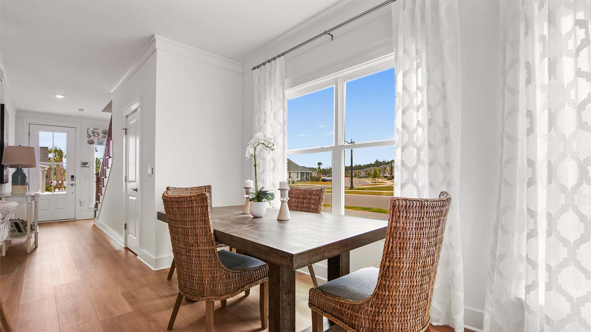 Open concept dining area by large window with EVP flooring.