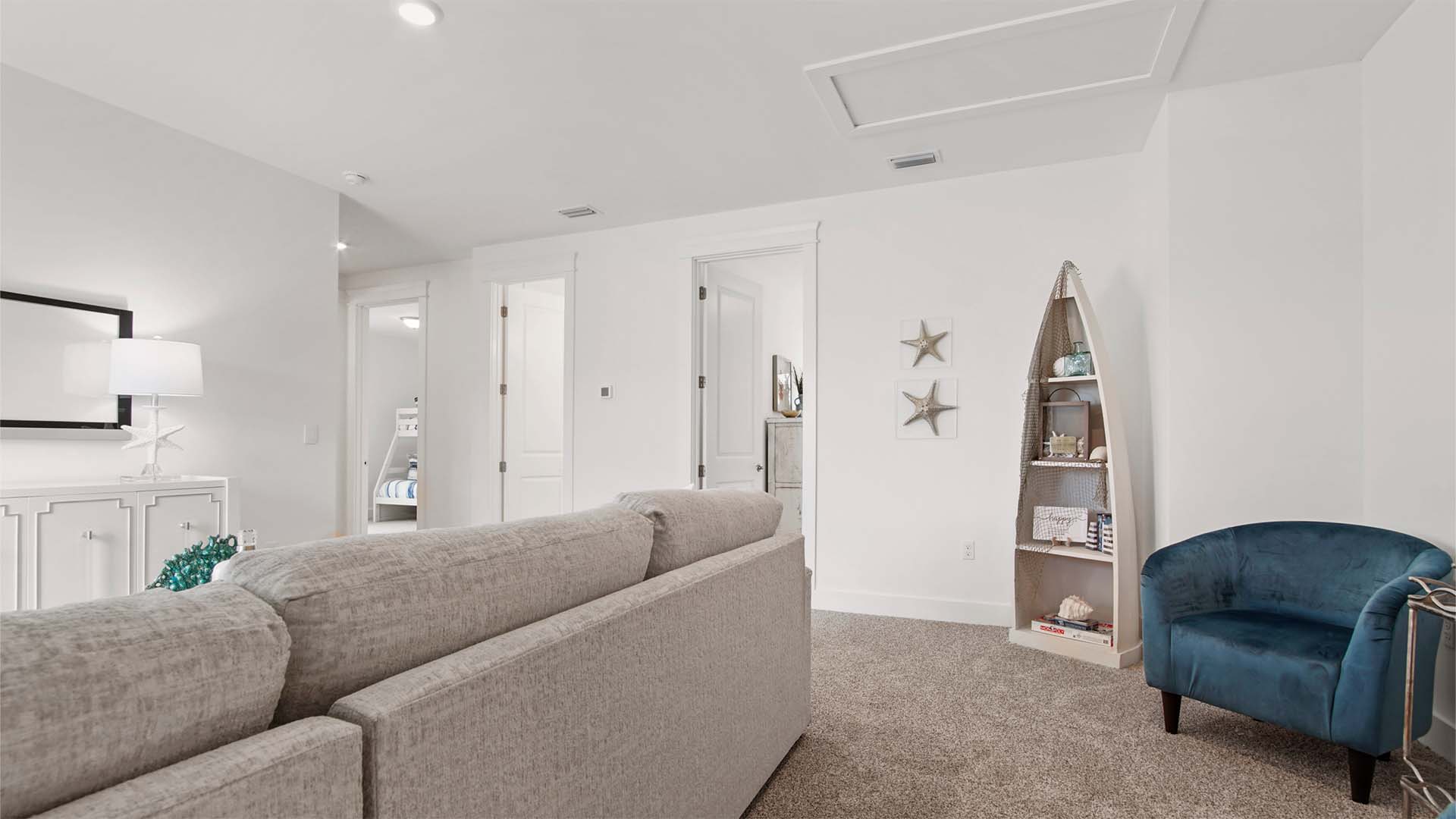 Upstairs family room with carpet flooring and next to guest bedrooms.
