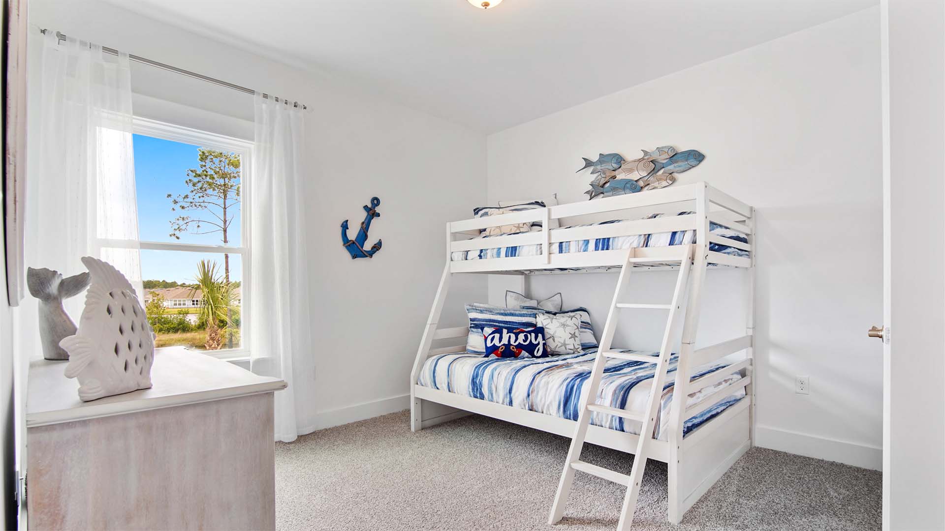 Bedroom three with carpet flooring and a window.