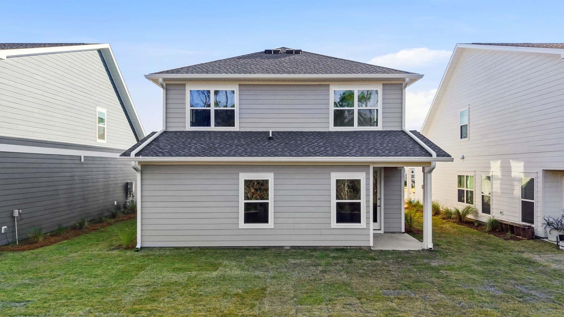The back of the home has a covered patio