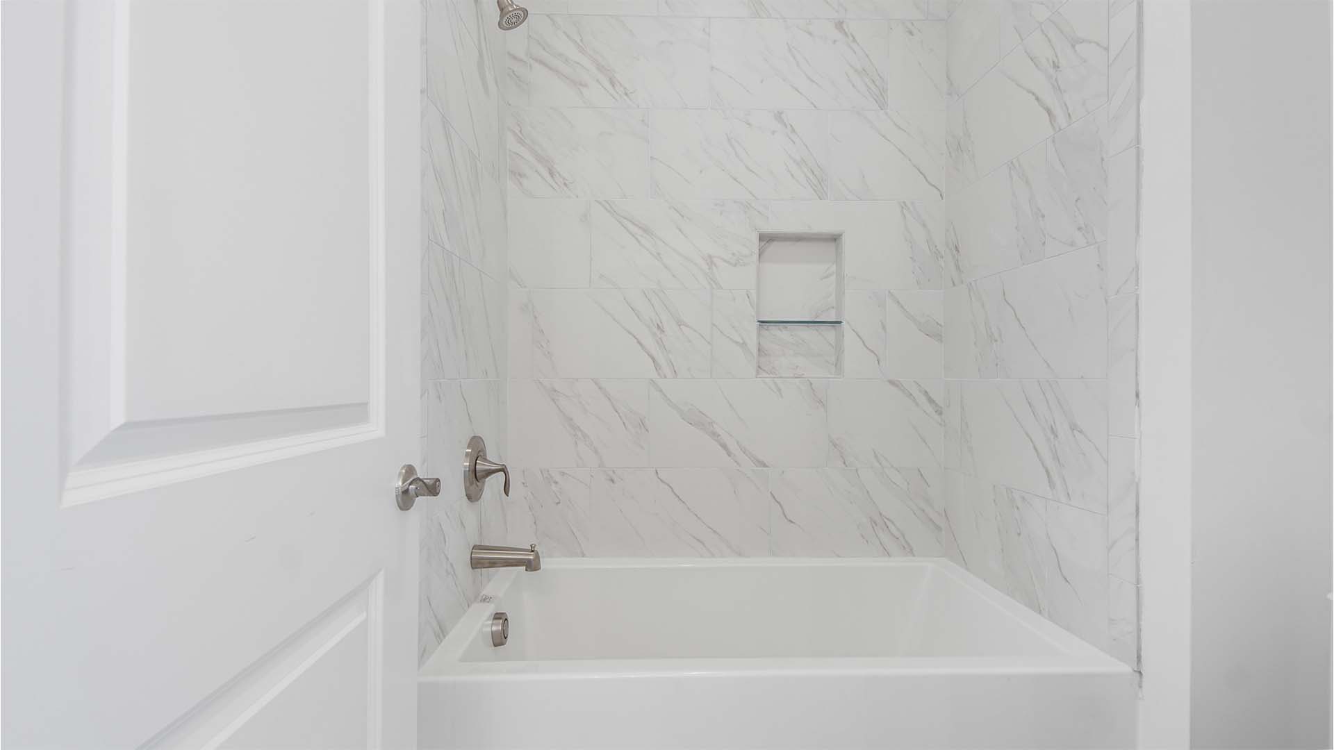 Jack and jill bathroom shower room with tub shower with tile walls.