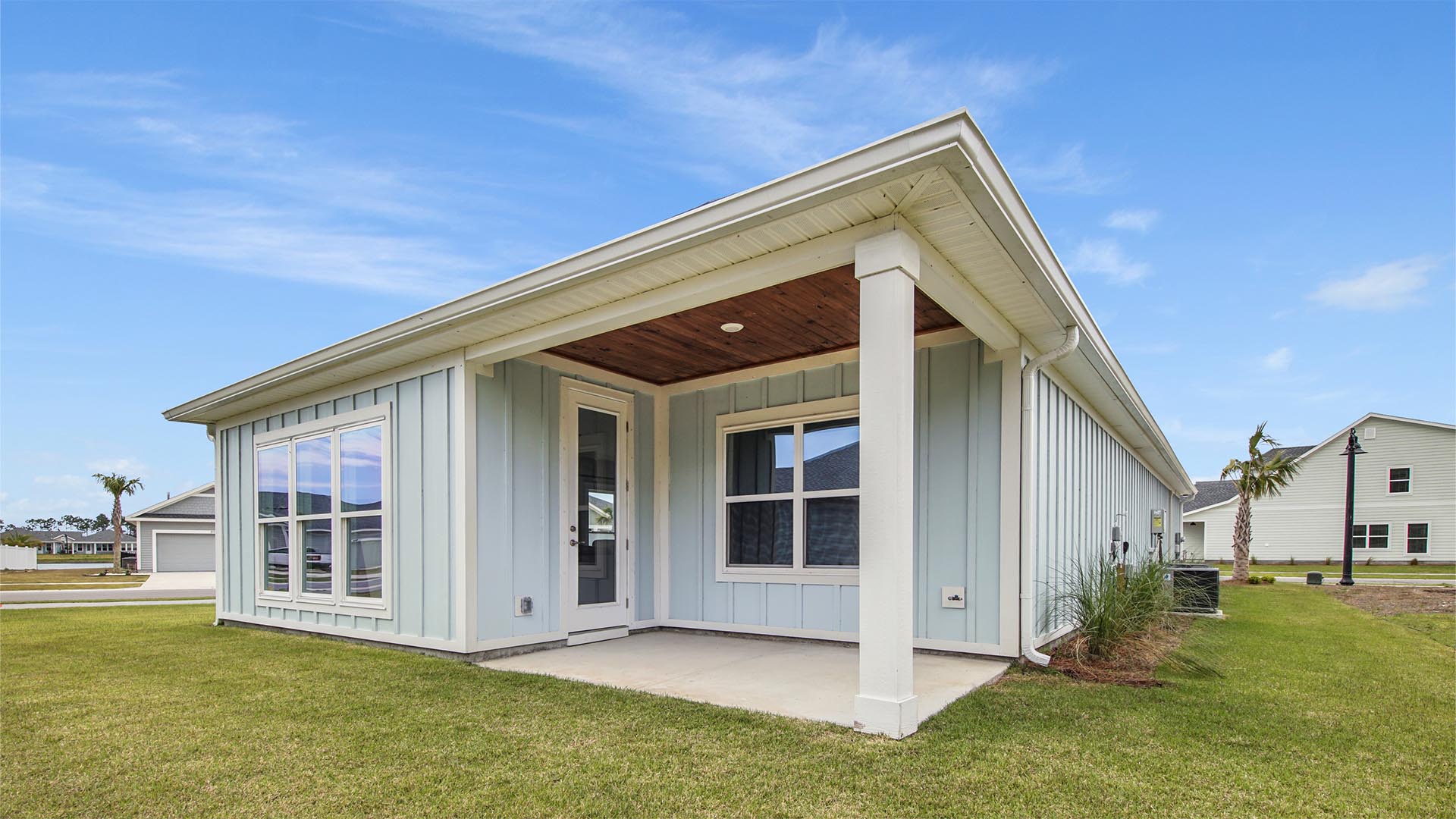Breakfast Point Bluewater plan rear of home with covered back patio and accent wood ceiling.