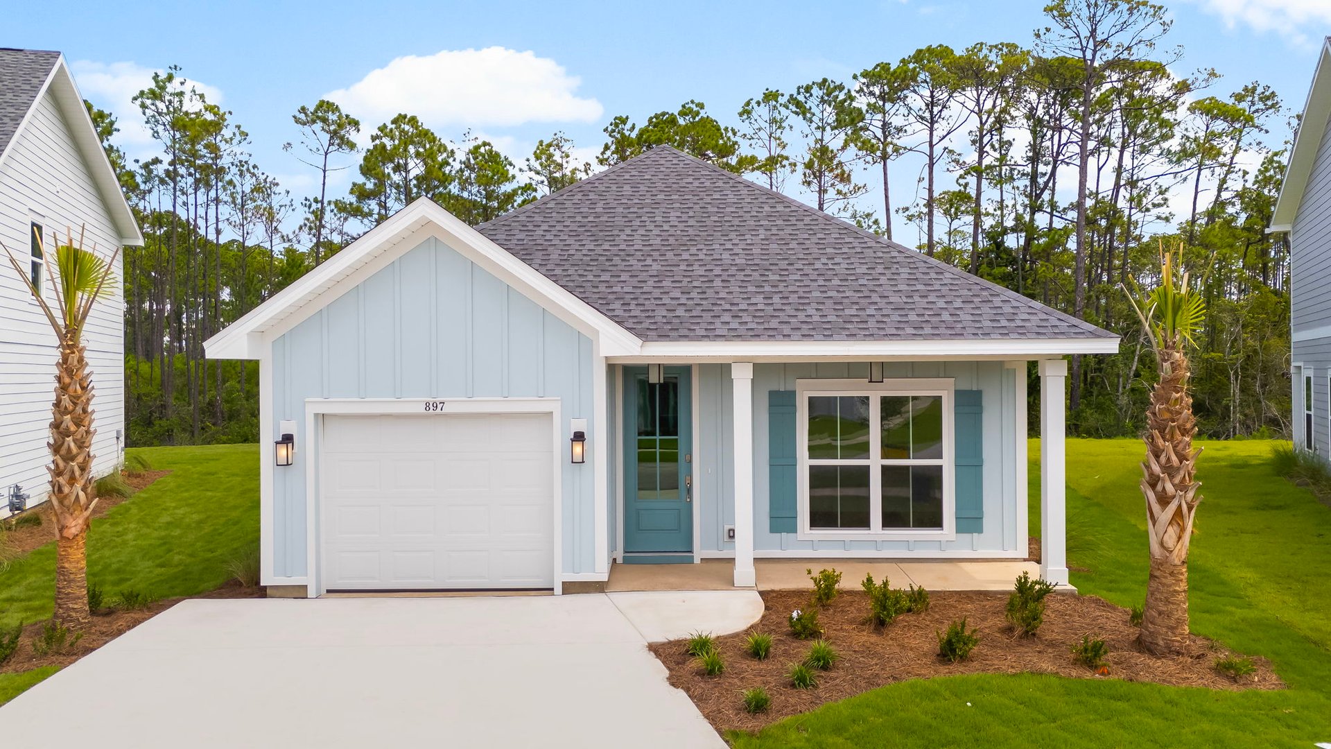 The Bluewater floorplan has a covered front patio and single car garage. This image shows a Bluewater at completion