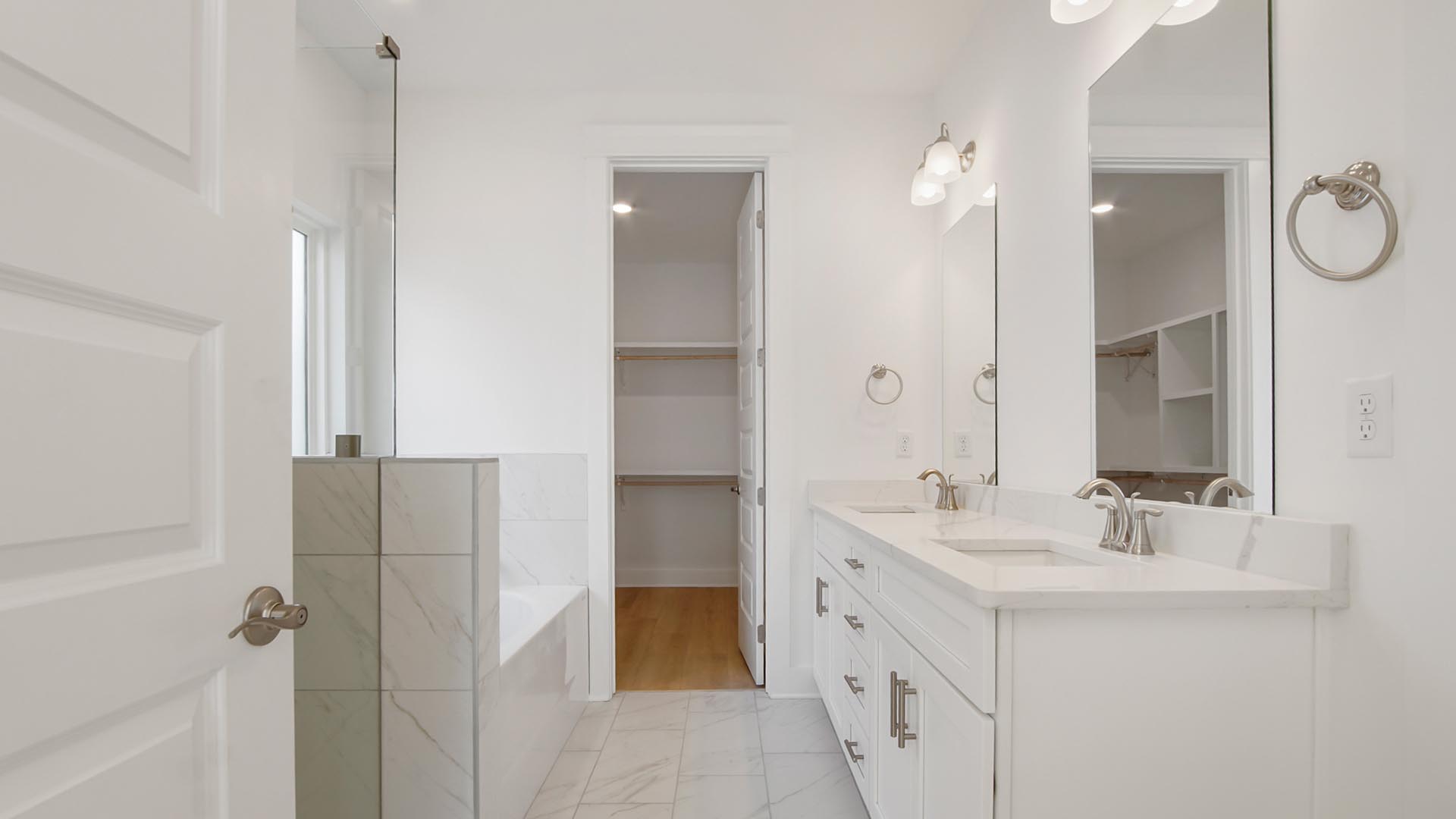 The primary bathroom has a vanity and closet with wood shelving