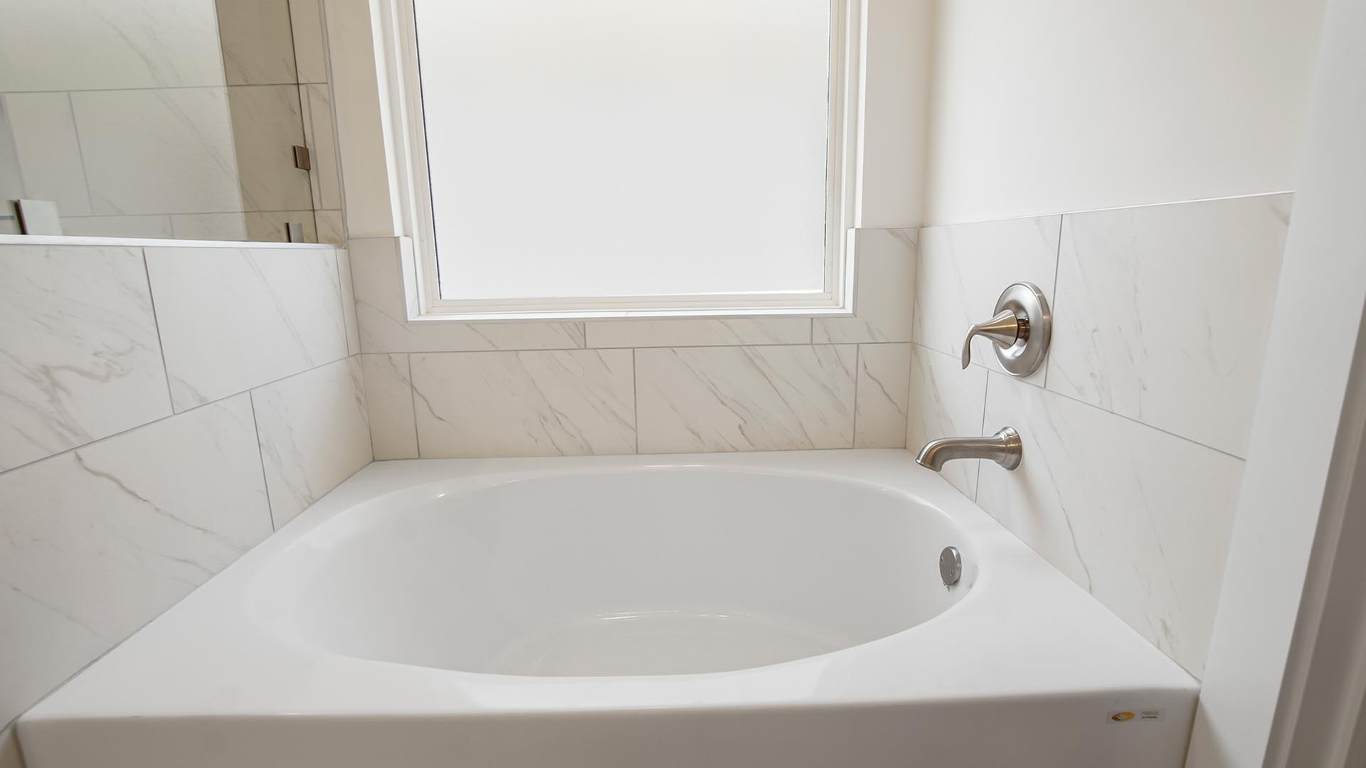 The primary bathroom has a large soak tub