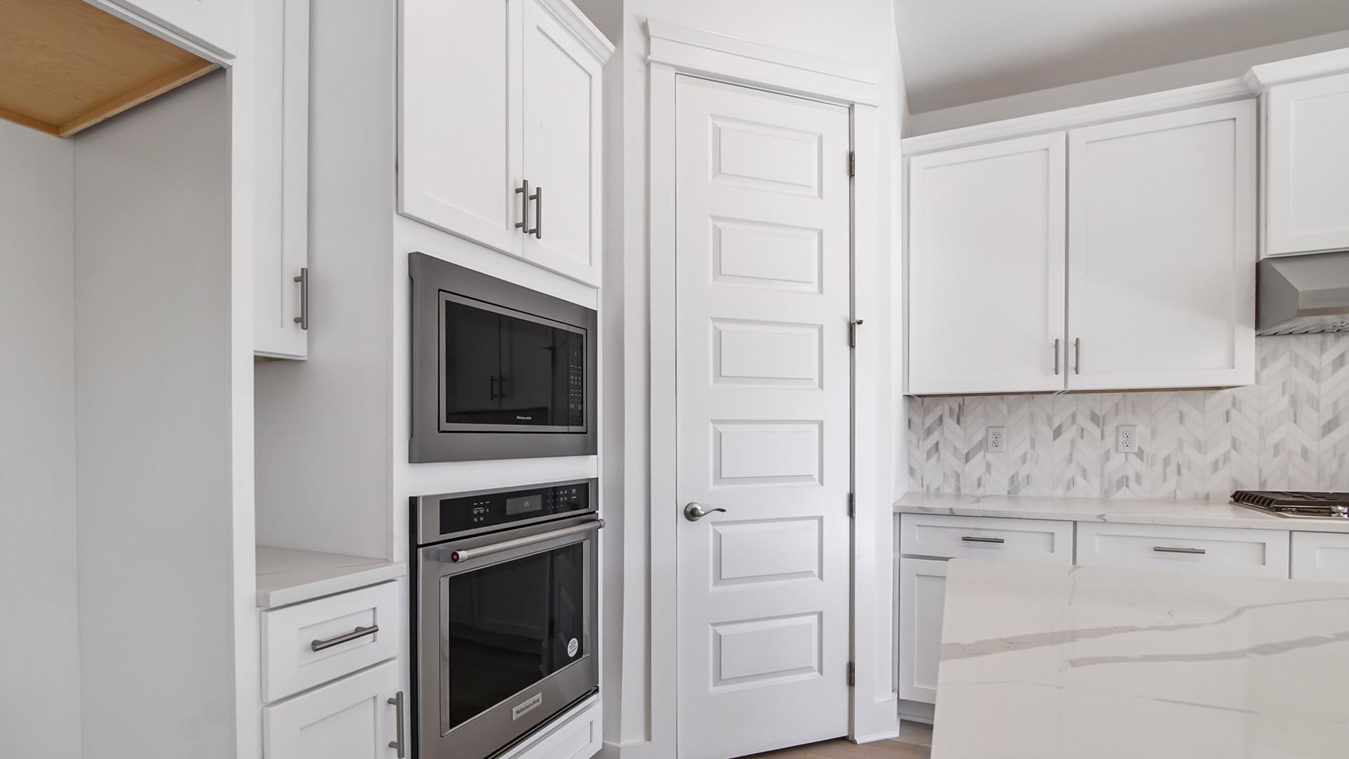 The kitchen features wall mount oven and microwave