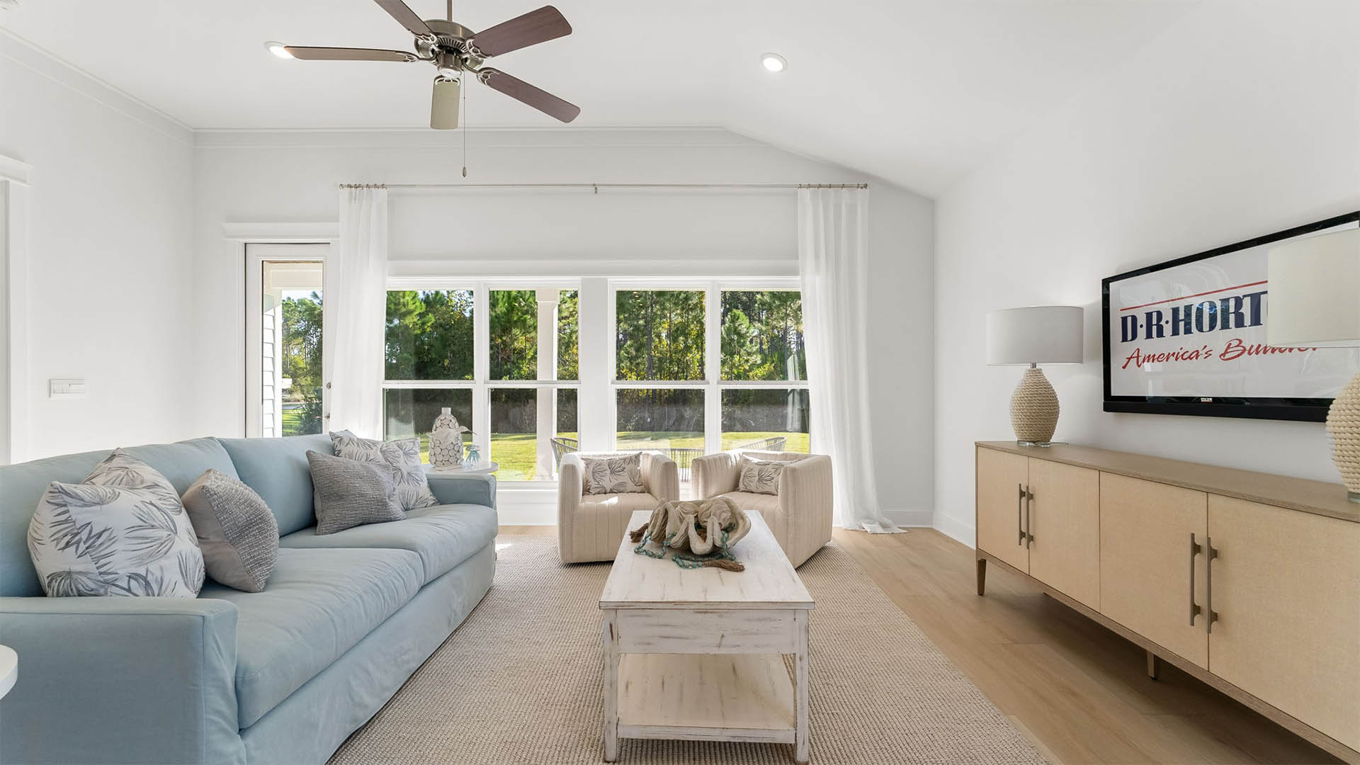 Expansive windows across the back of the home lend to a light filled room