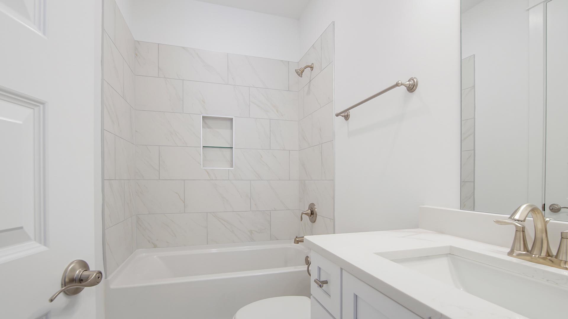 Full bathroom in bedroom has a single vanity with quartz countertop