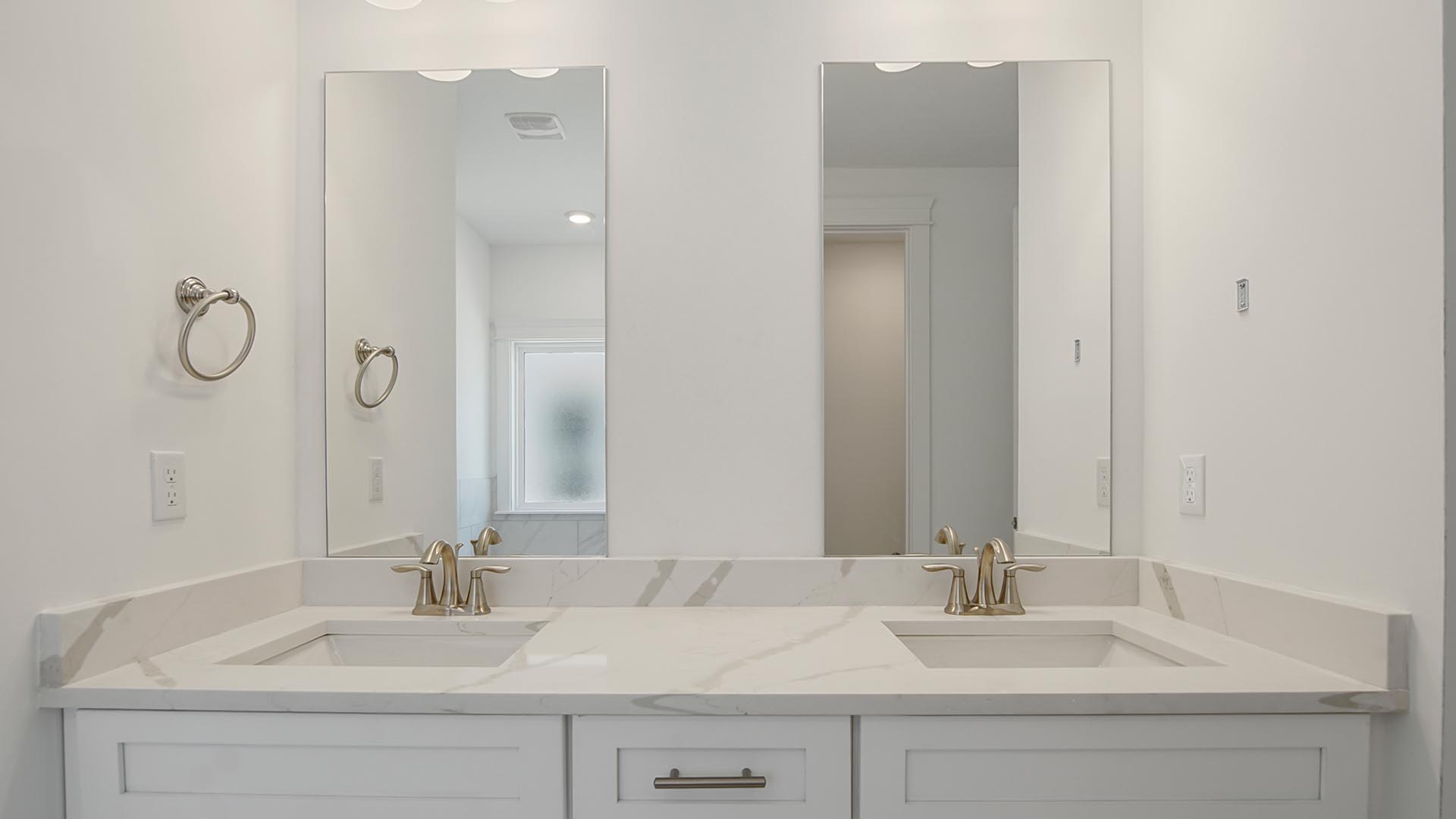 The dual sink vanity has separate mirrors