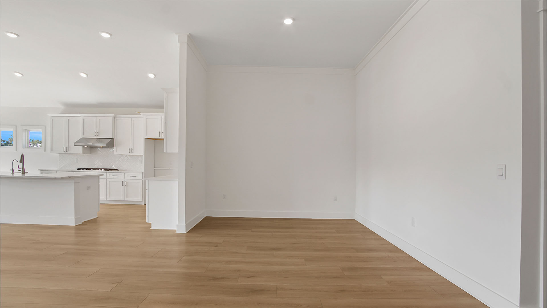 Dining area next to open-concept kitchen and EVP flooring and tall ceilings.