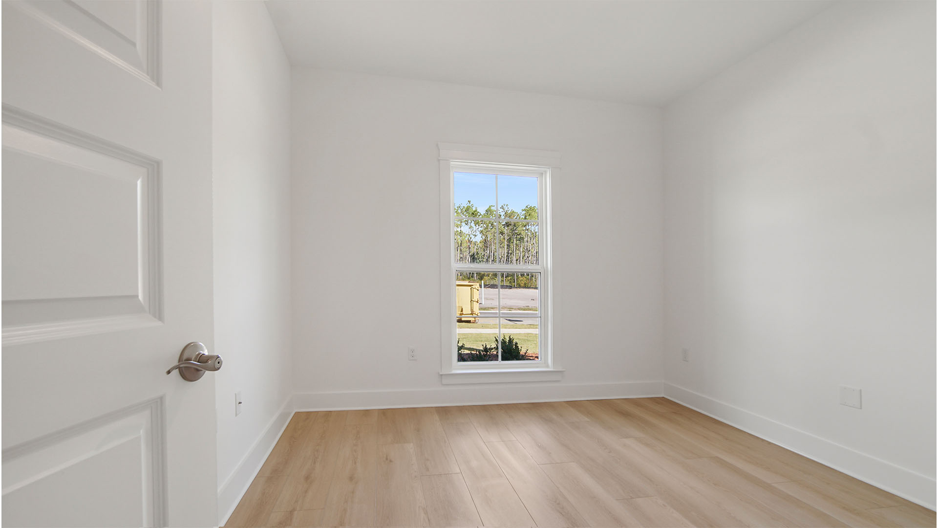 Bedroom three with large window and EVP flooring.