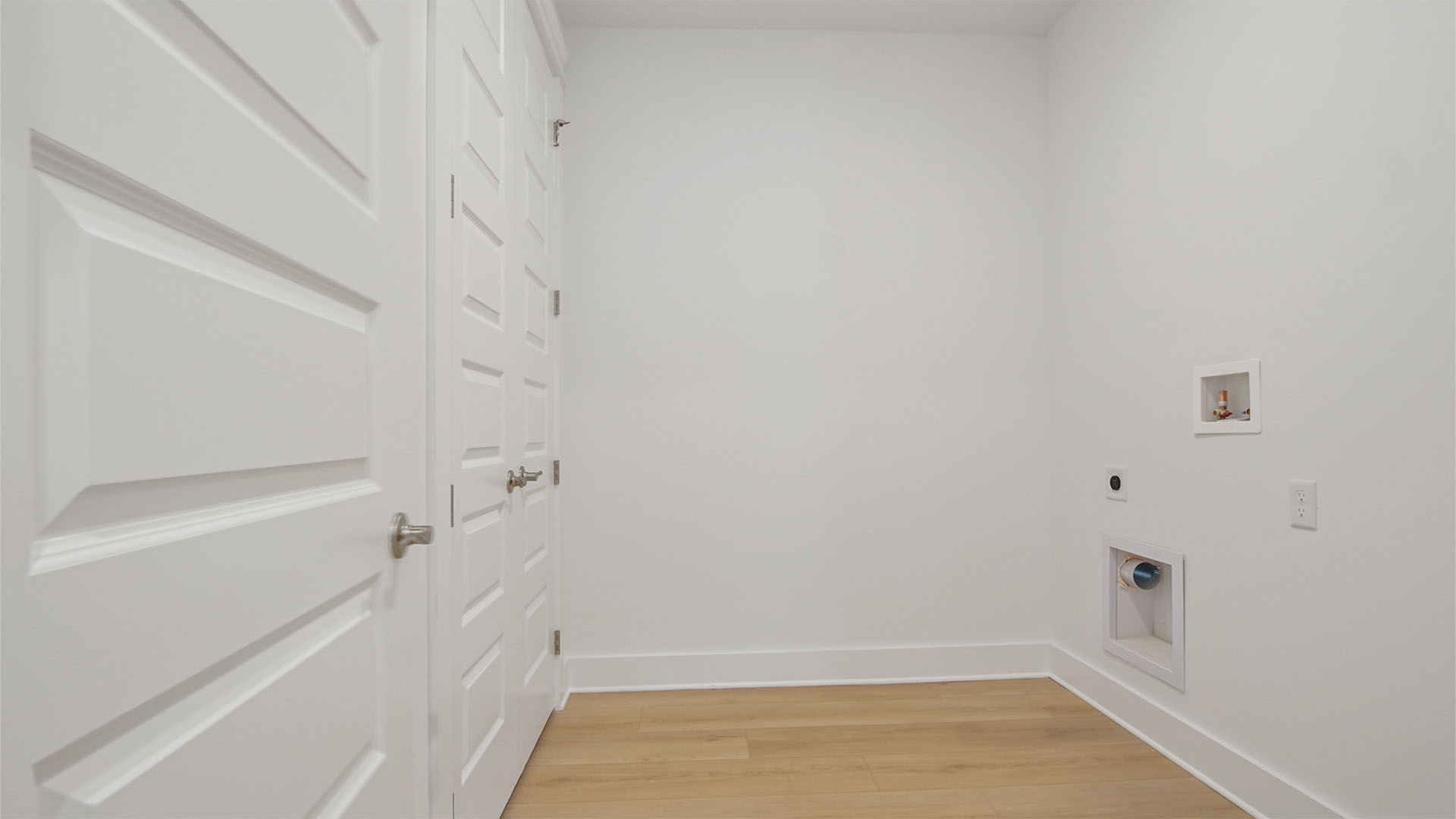 Laundry room with EVP flooring and storage closet.