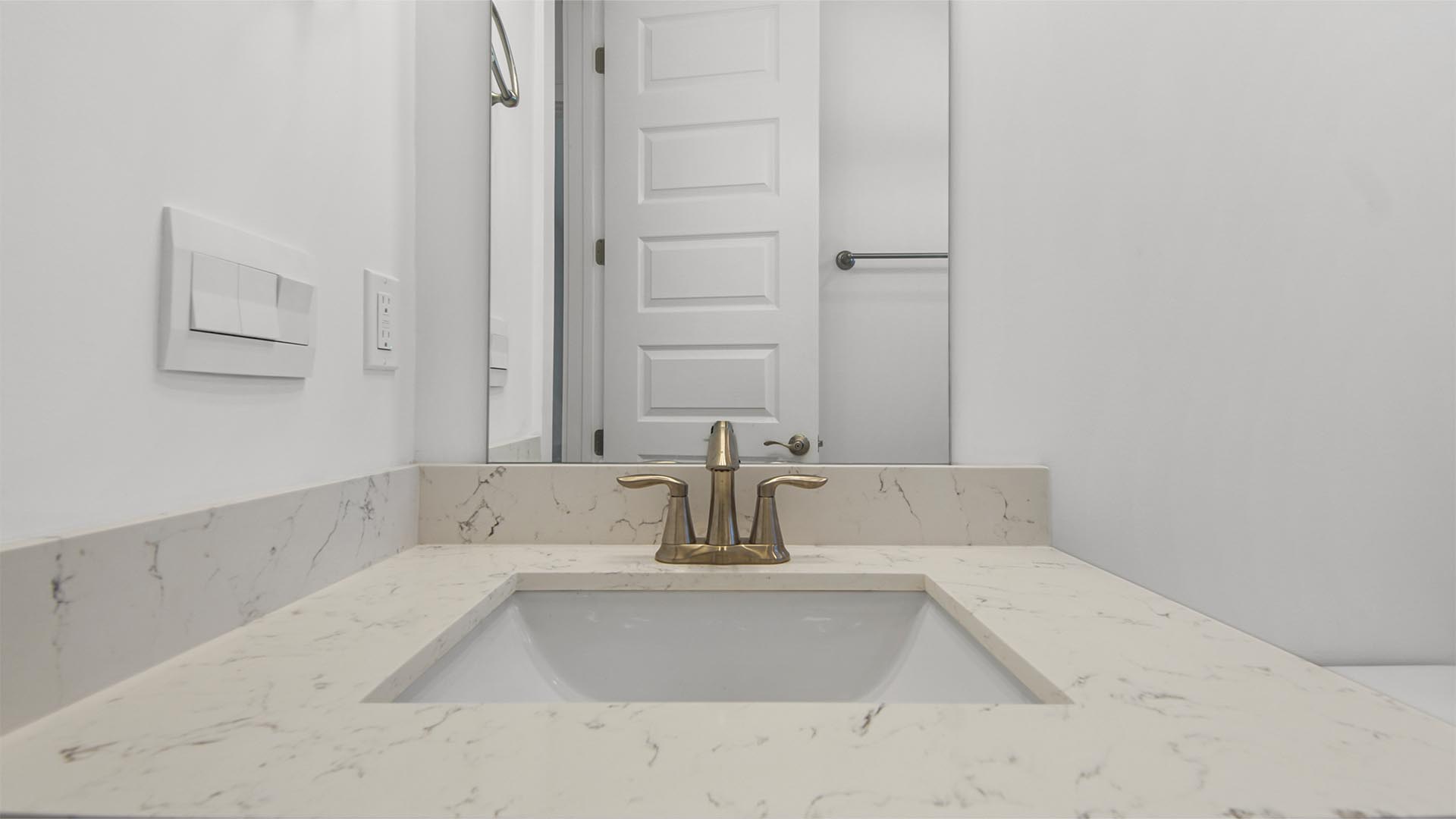 Bathroom two single vanity with quartz countertops and undermount sink.