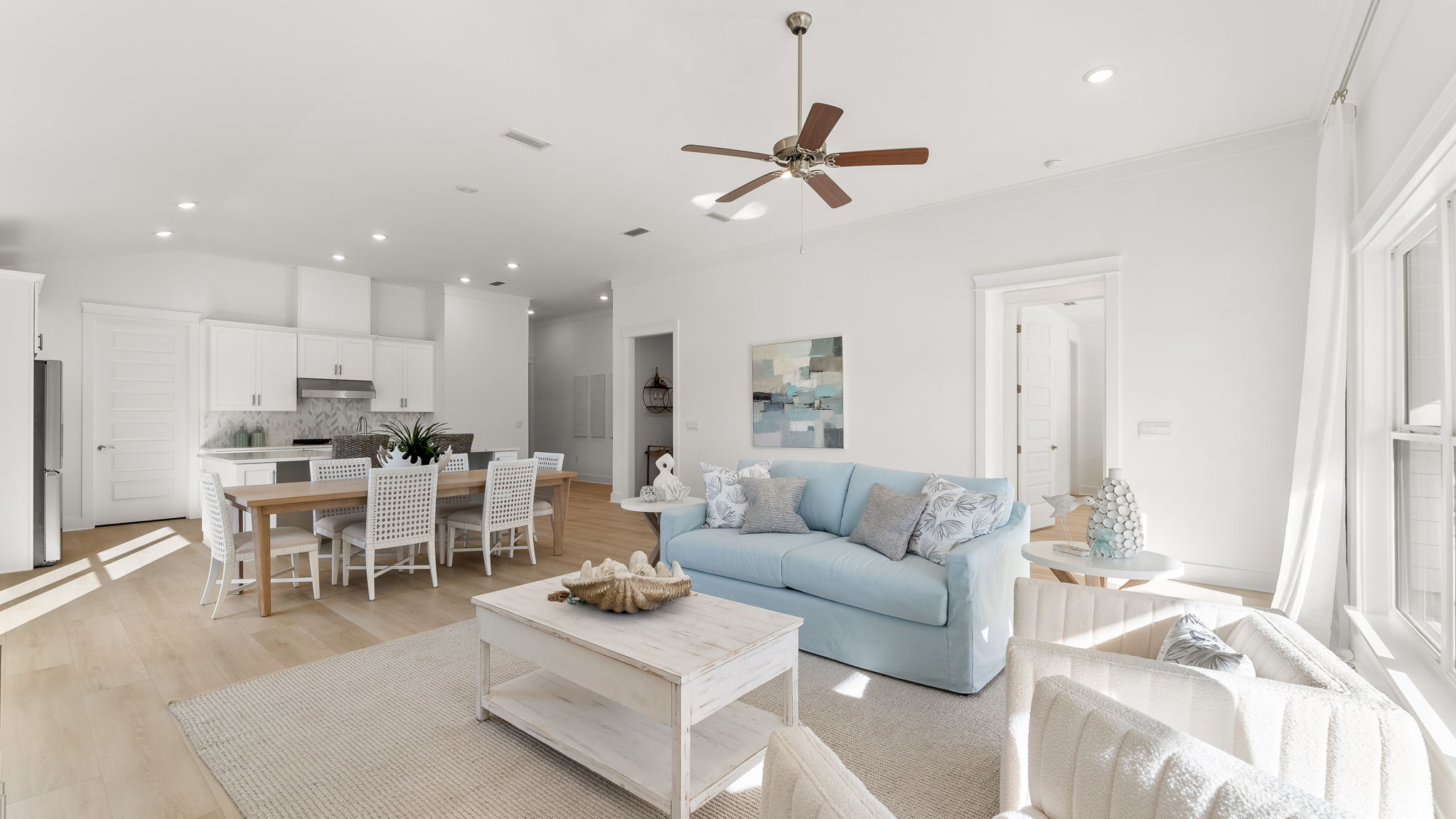 Expansive windows across the back of the home lend to a light filled room