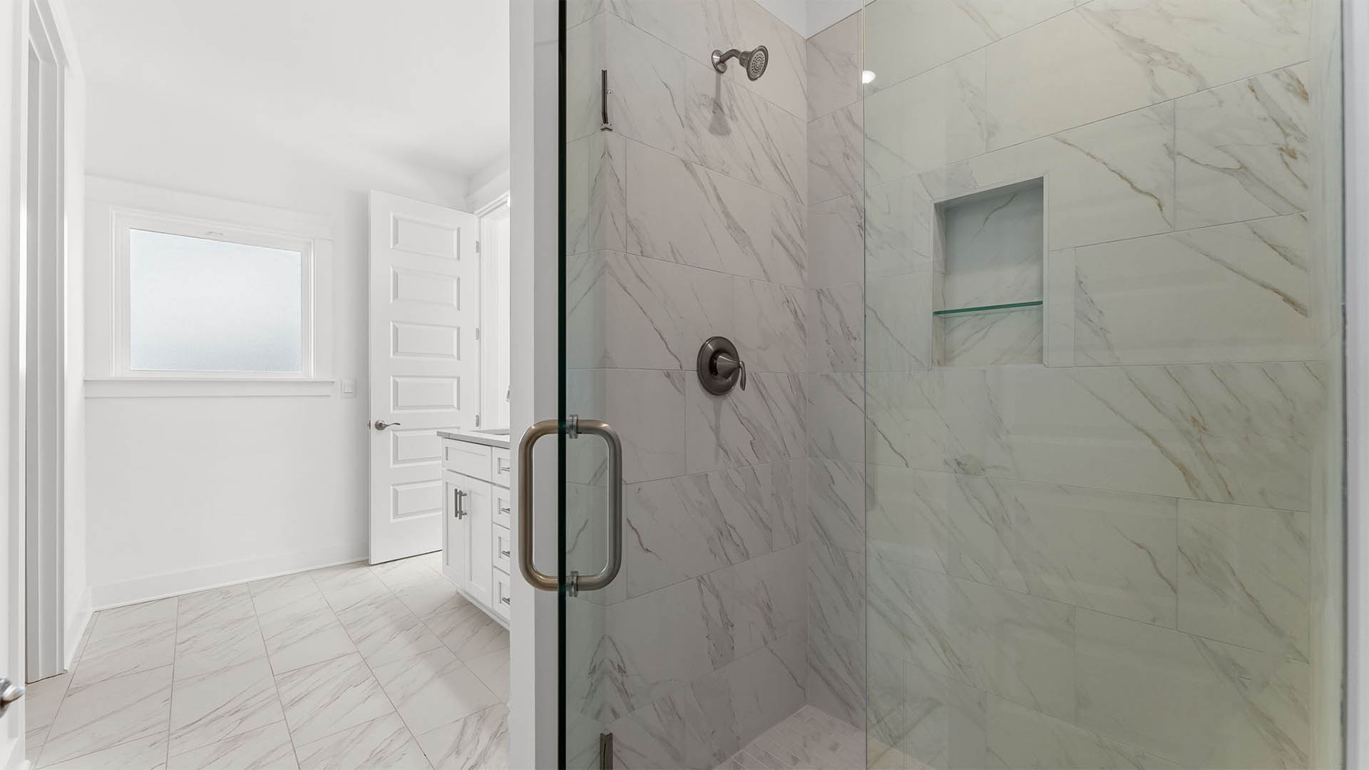 The primary bathroom has separate tile shower with glass enclosure