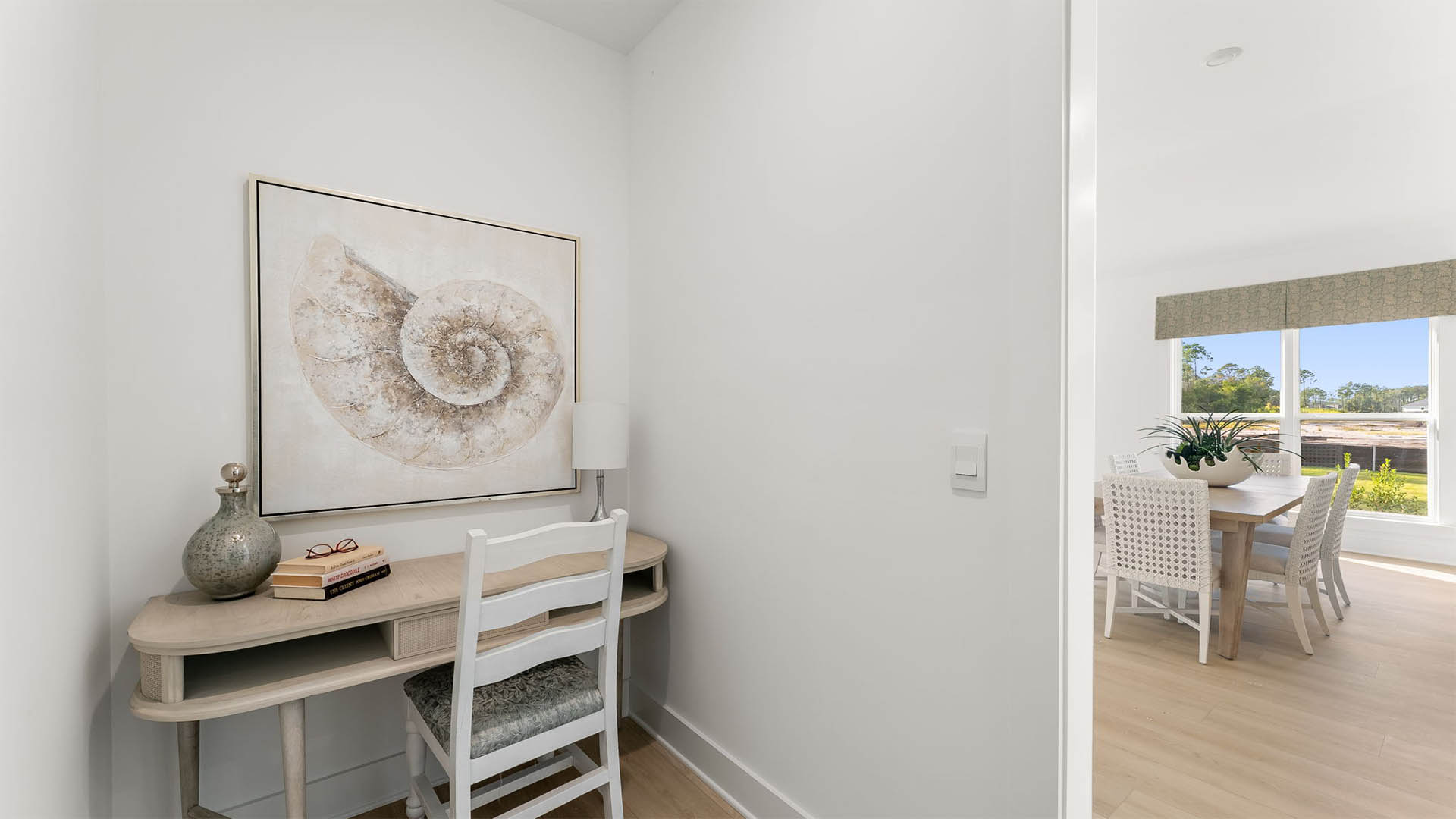 There is a nook for a work station or folding area off the laundry room