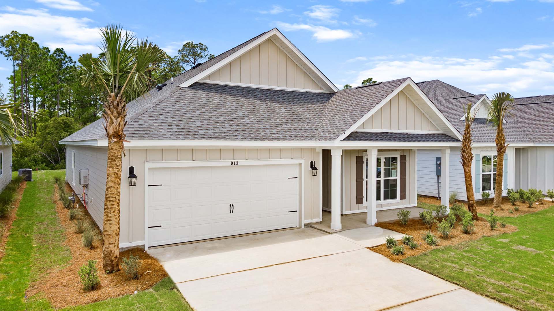 This home has a covered front porch and two car garage
