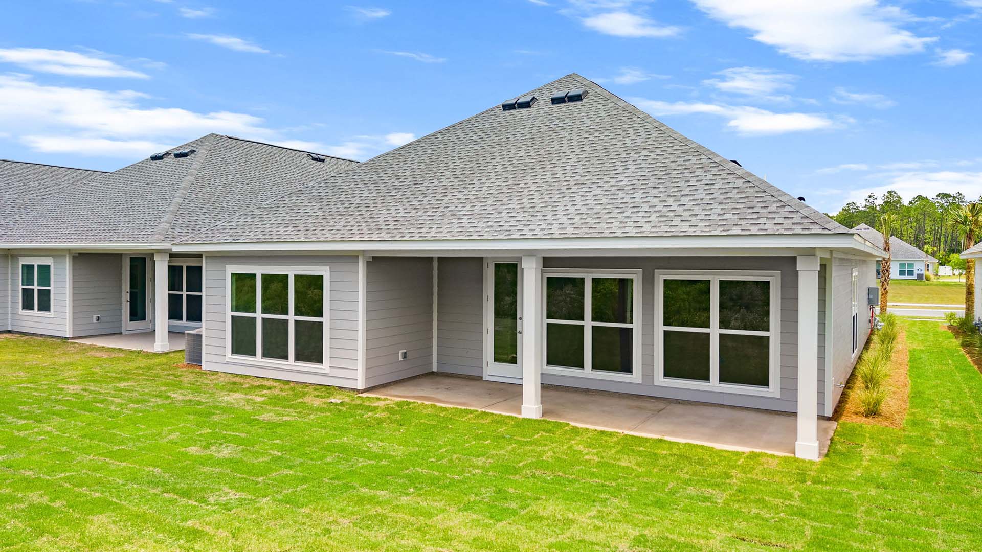 The back of the home has covered patio