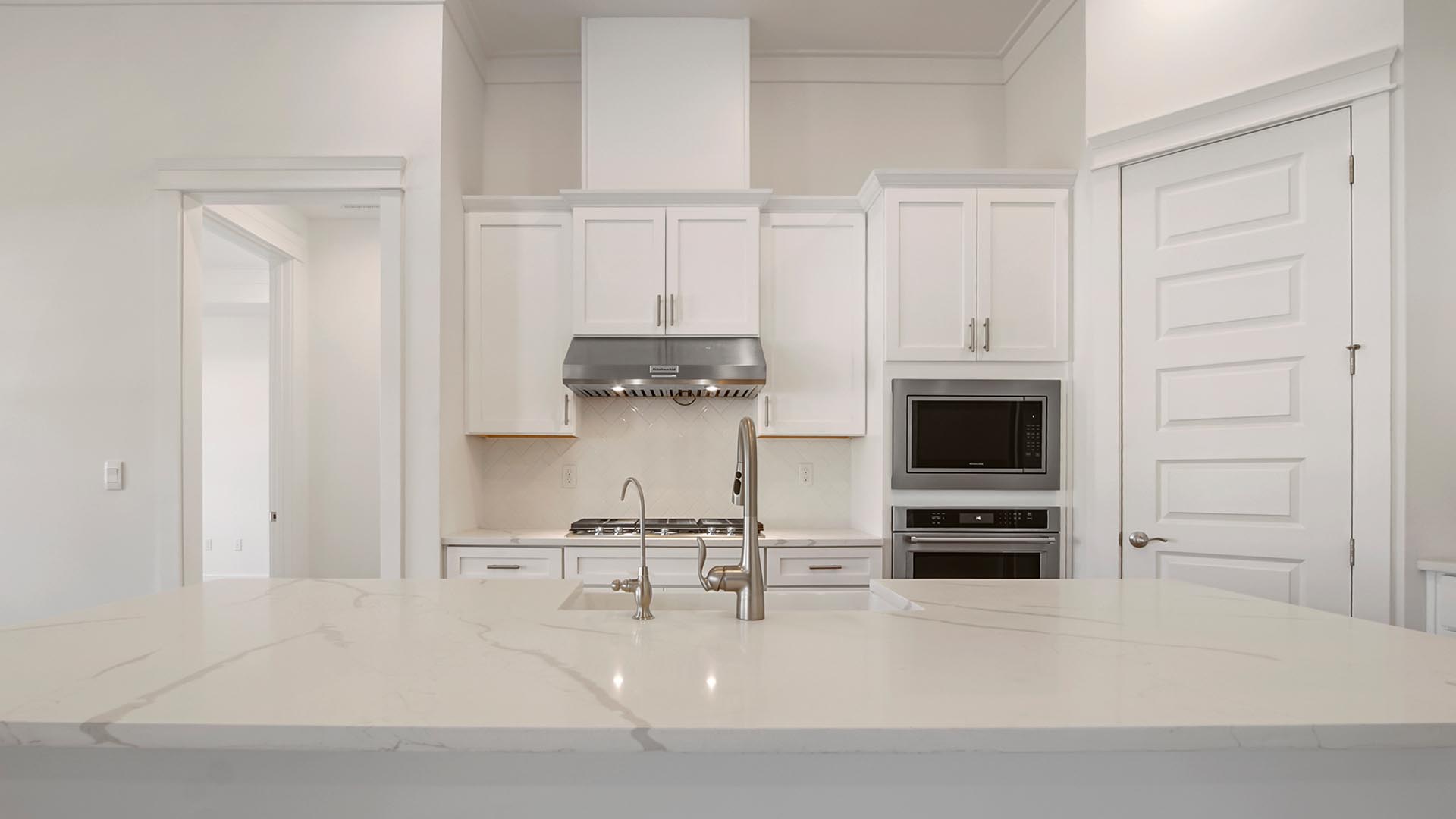 Elegant quartz countertops highlight the beautiful kitchen