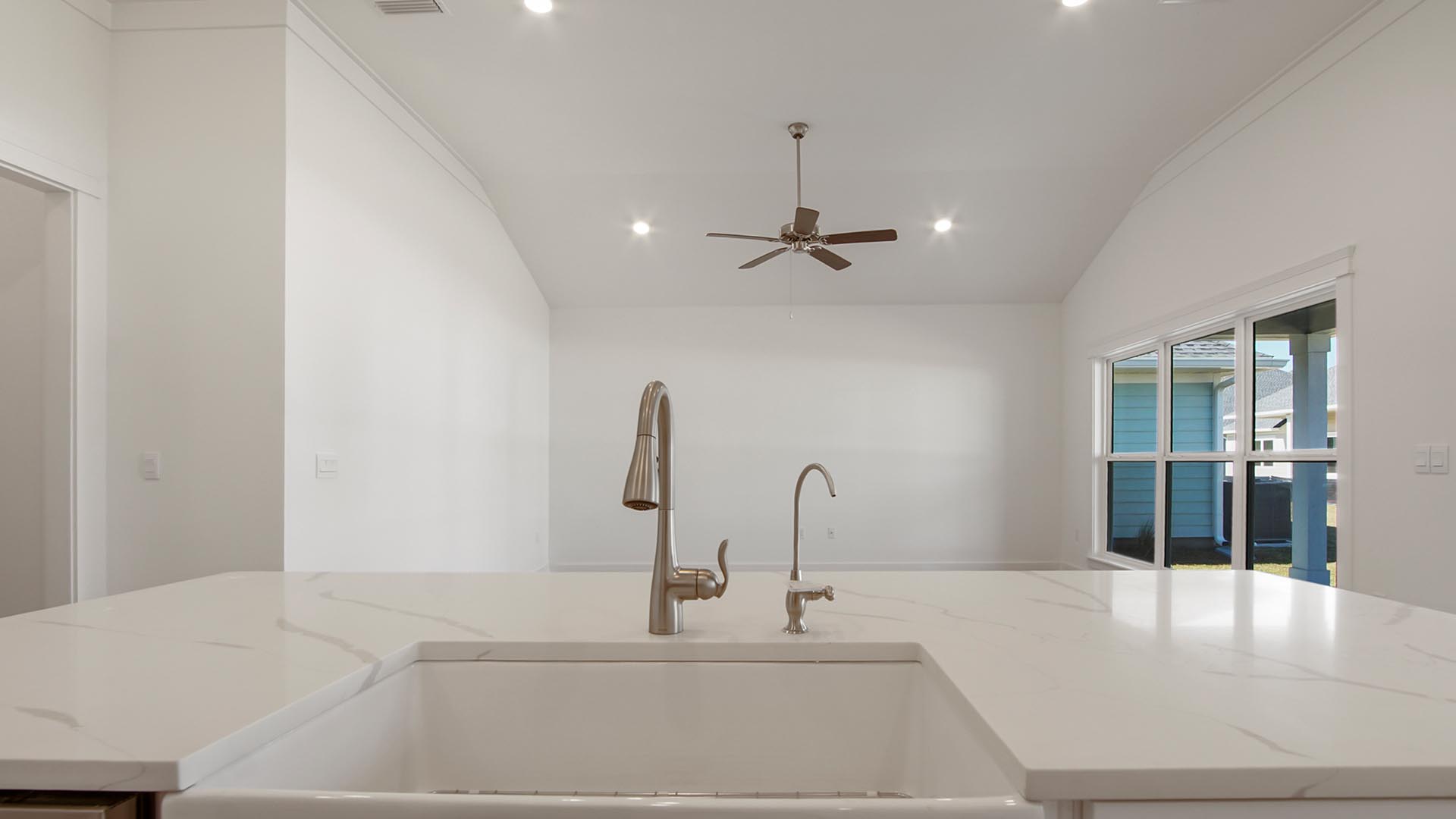 The center island has a farm style sink and features the dishwasher as well as a dedicated faucet for water filtration hookup