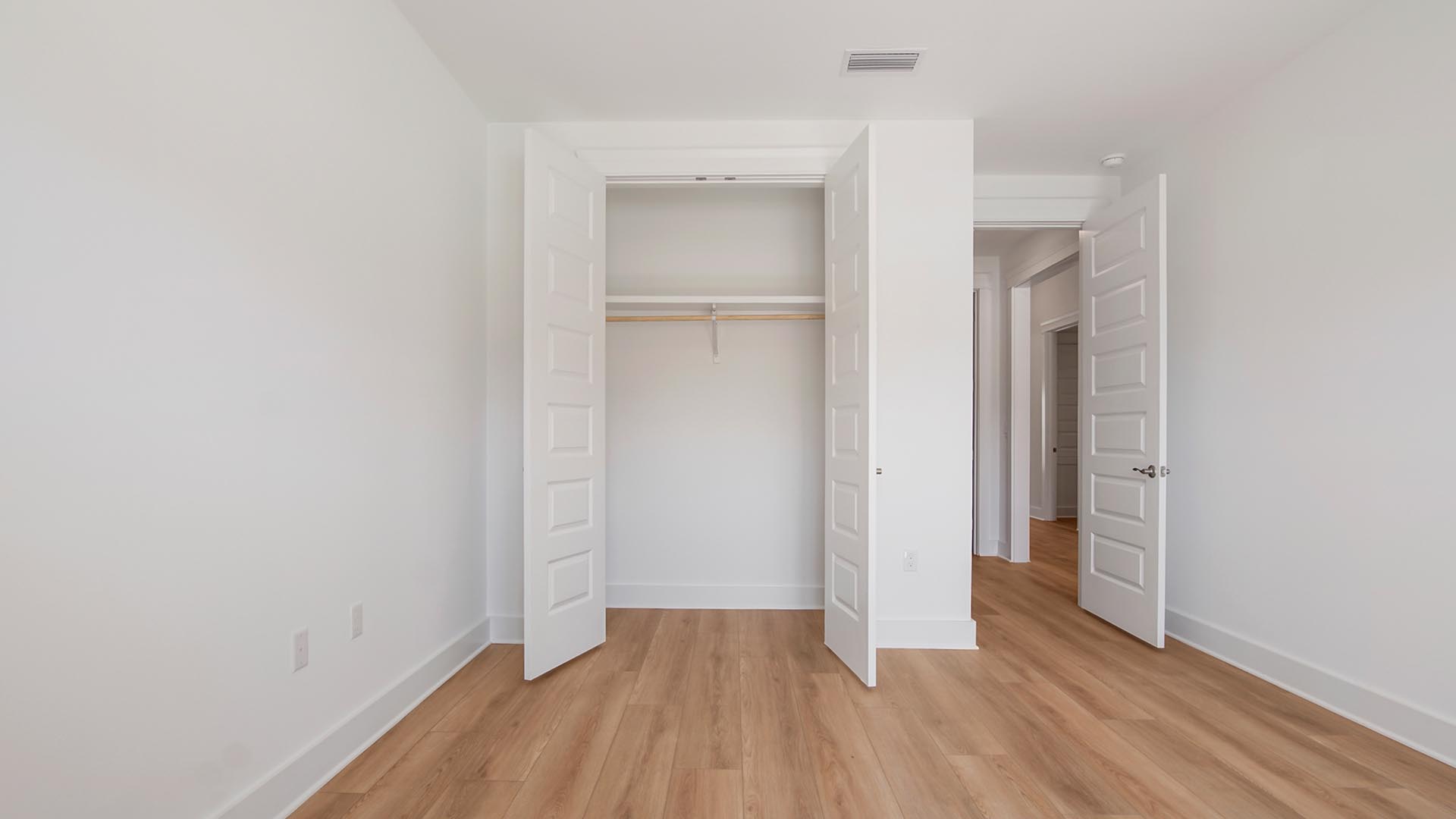 Bedroom three has EVP floors and a spacious closet for storage