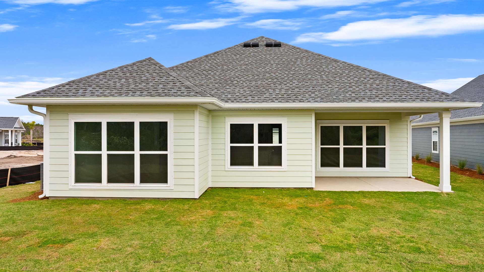 The back of the home has a covered patio