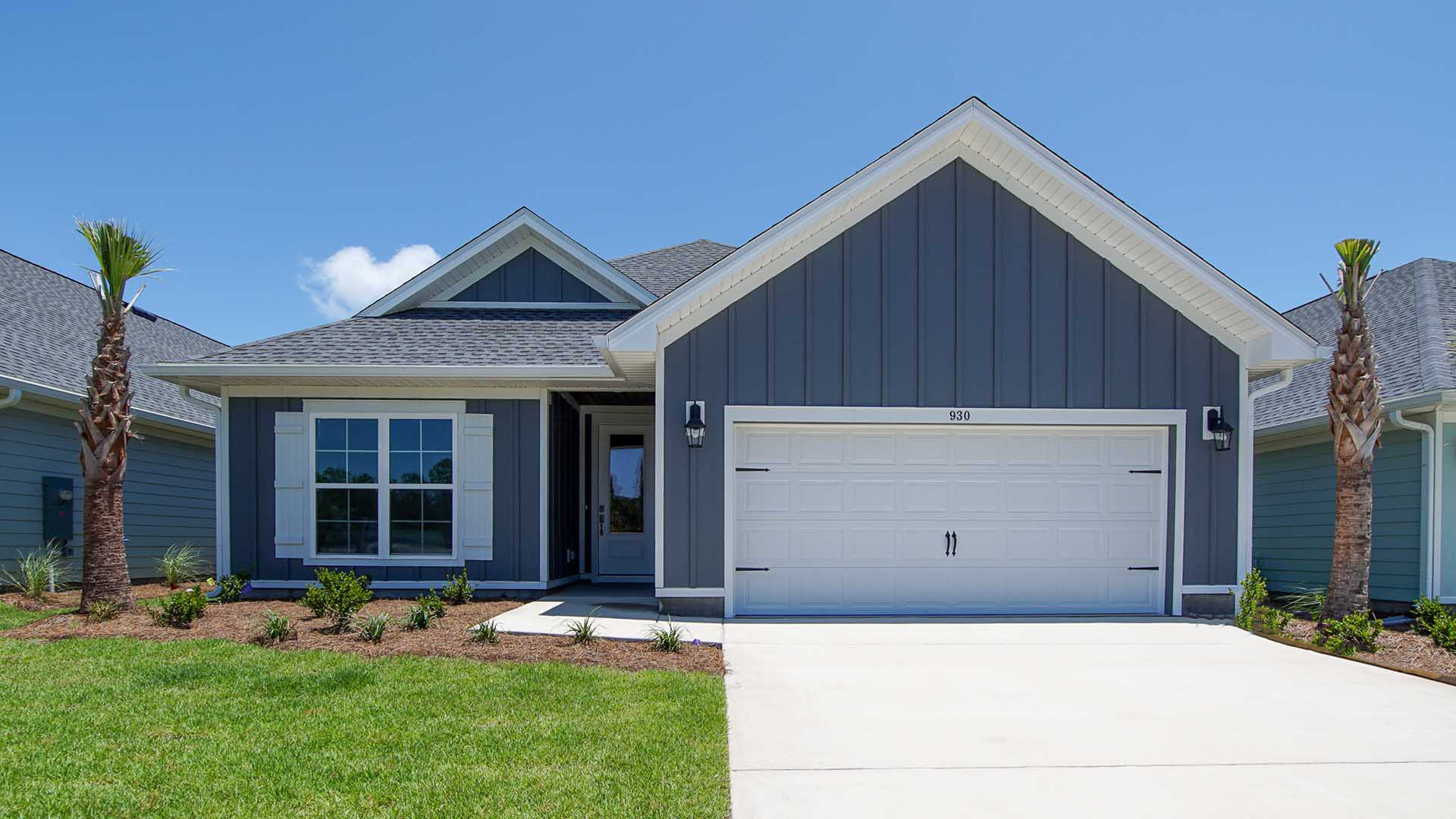 This image shows a similar Lily floorplan at completion with blue exterior, white garage and a covered front patio at completion