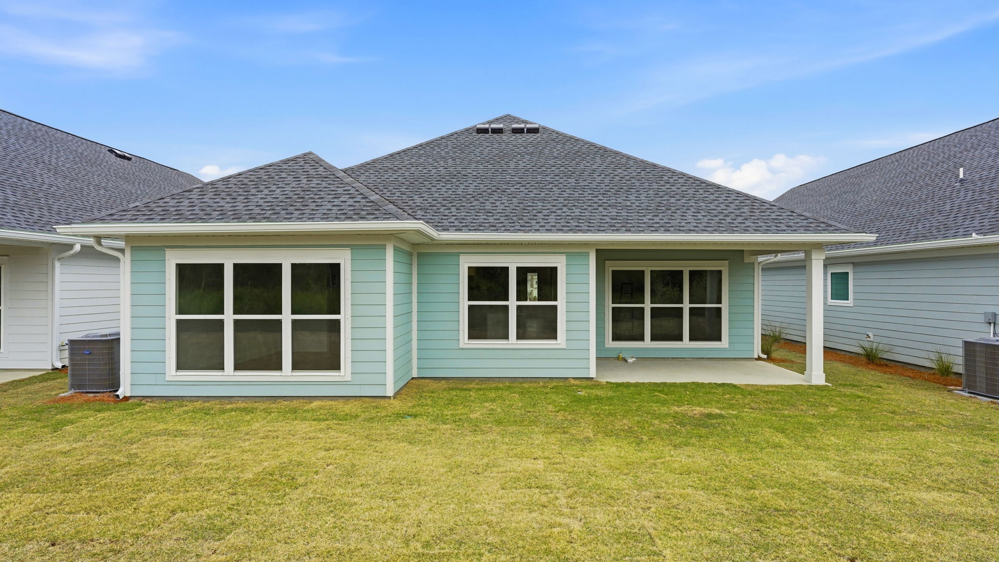 The back of the home has a covered patio for dining or seating area