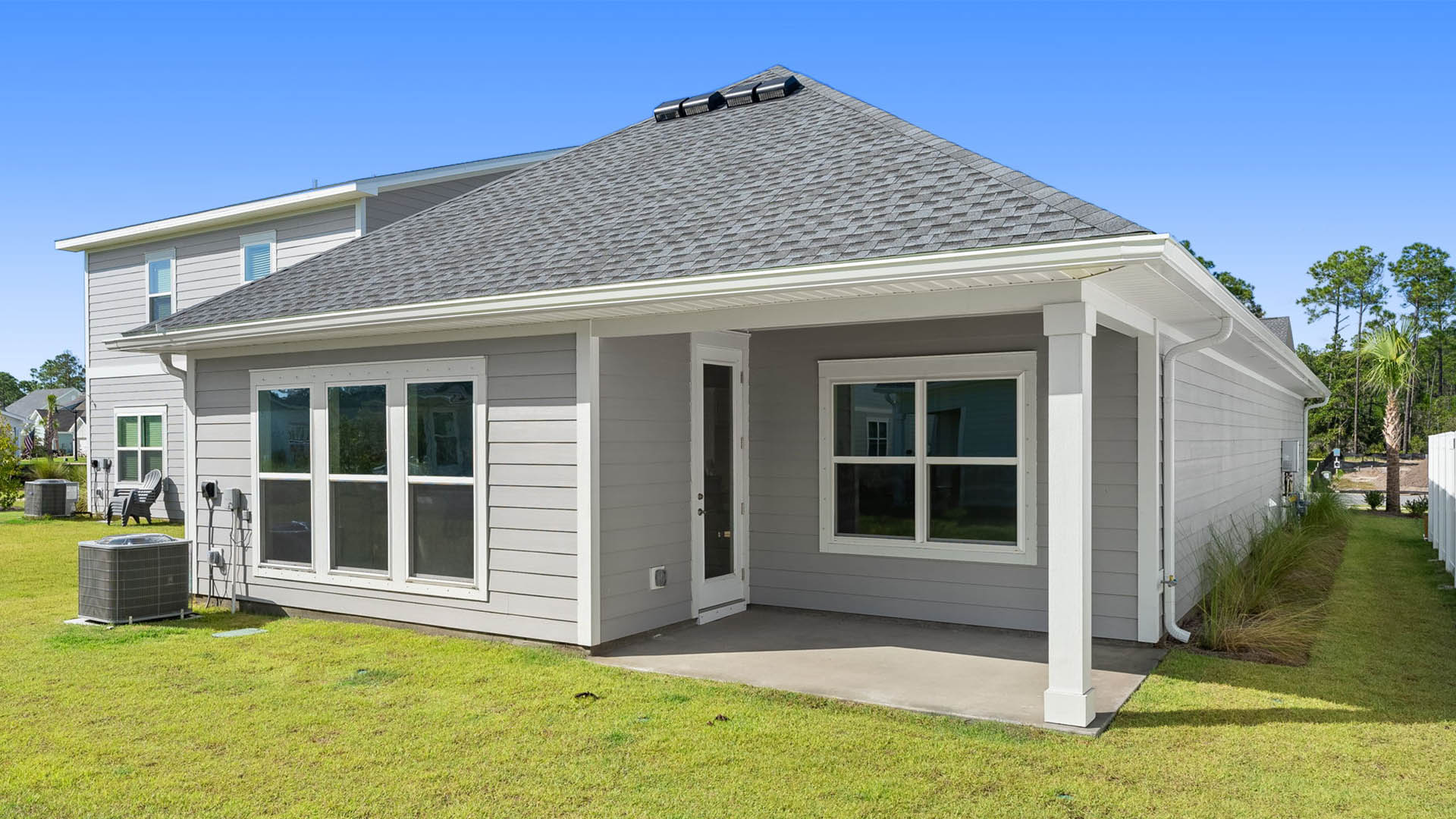 The back of this home has a covered patio