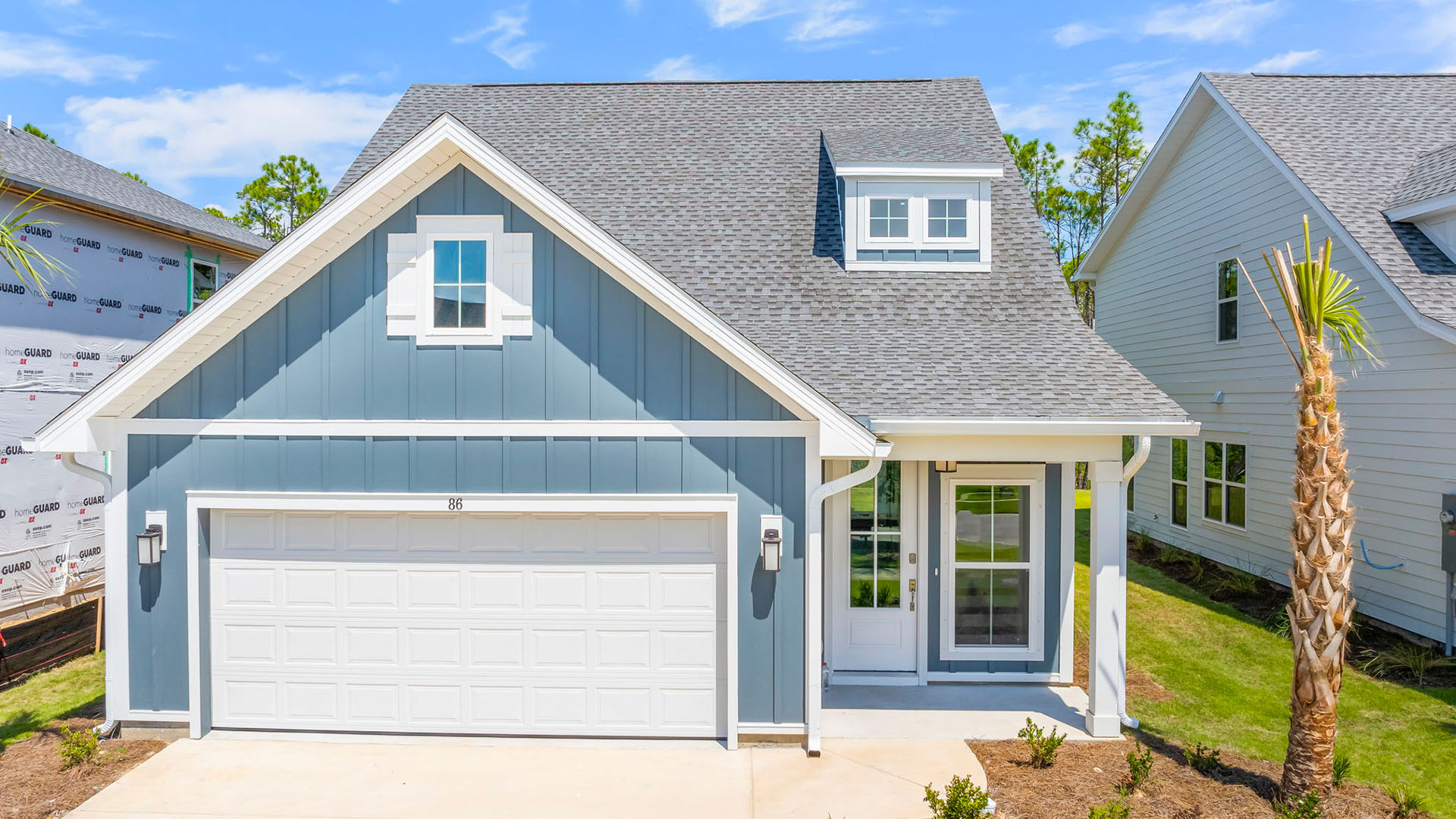 The Bluewater has a covered front porch and a two car garage. The exterior features Hardie siding