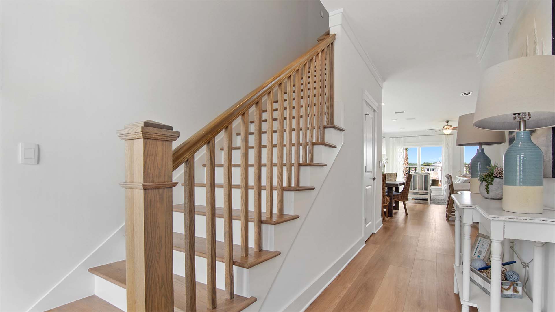 Foyer with stairs and half bath and EVP flooring.