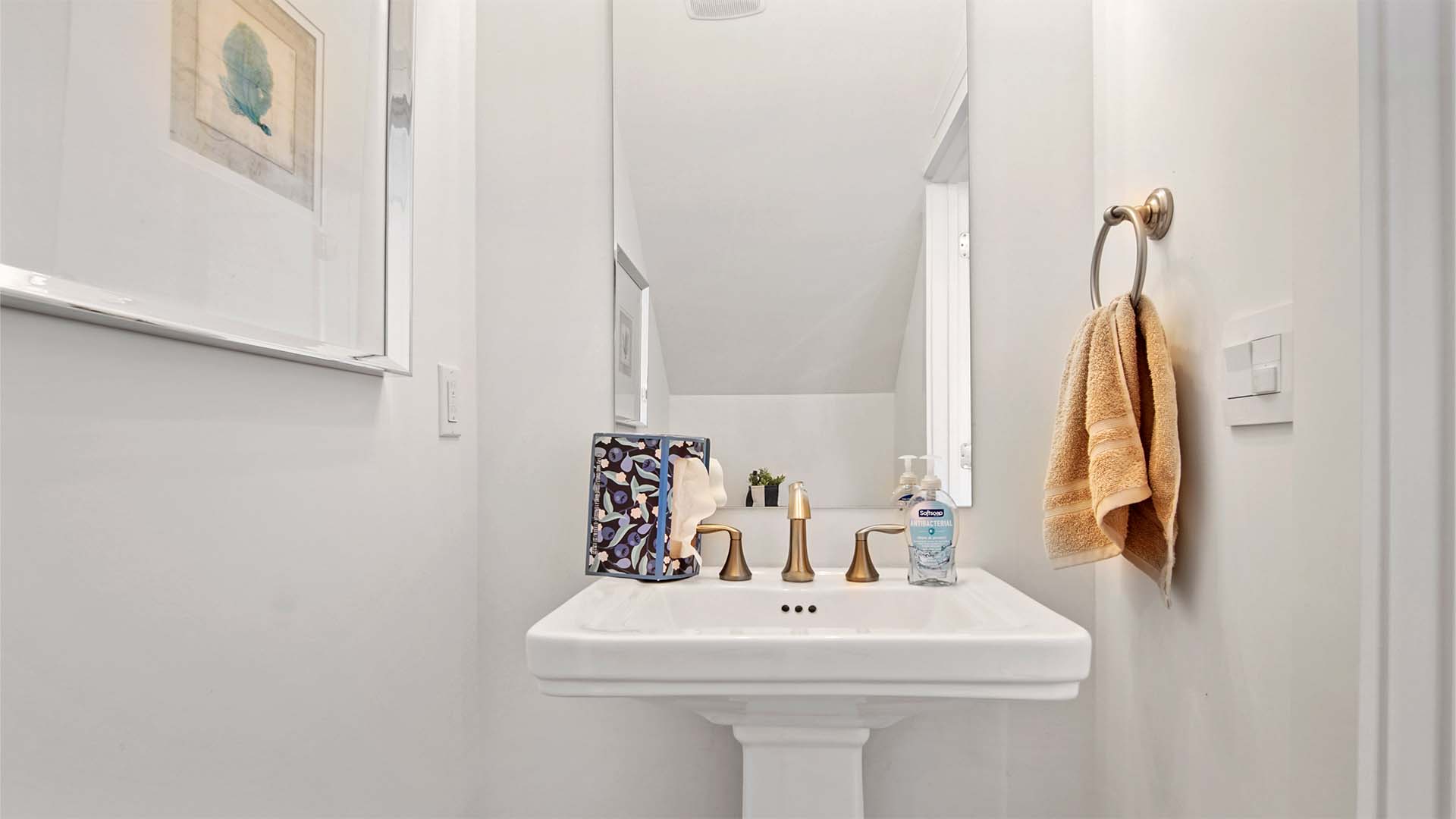 Half bathroom with pedestal sink and single mirror.