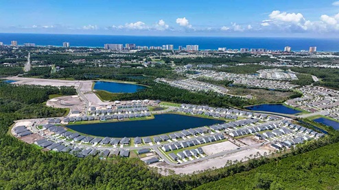 Aerial view of Breakfast Point showing homes and ponds and the Gulf of Mexico.