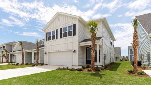 Breakfast Point Key Largo plan front of two story home with large window and two car garage and covered front entrance.