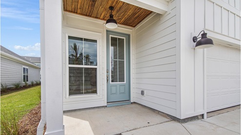 Breakfast Point Key Largo plan covered front entrance with accent wood ceiling.