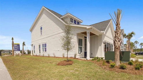 Breakfast Point Islamorada plan model home with white James Hardie color plus siding and covered front entrance. Panama City Beach Florida