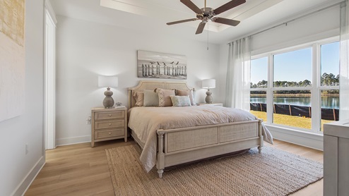 The primary bedrooms in Breakfast Point East have upgraded bathroom finishes with tile showers, quartz countertops and white cabinetry