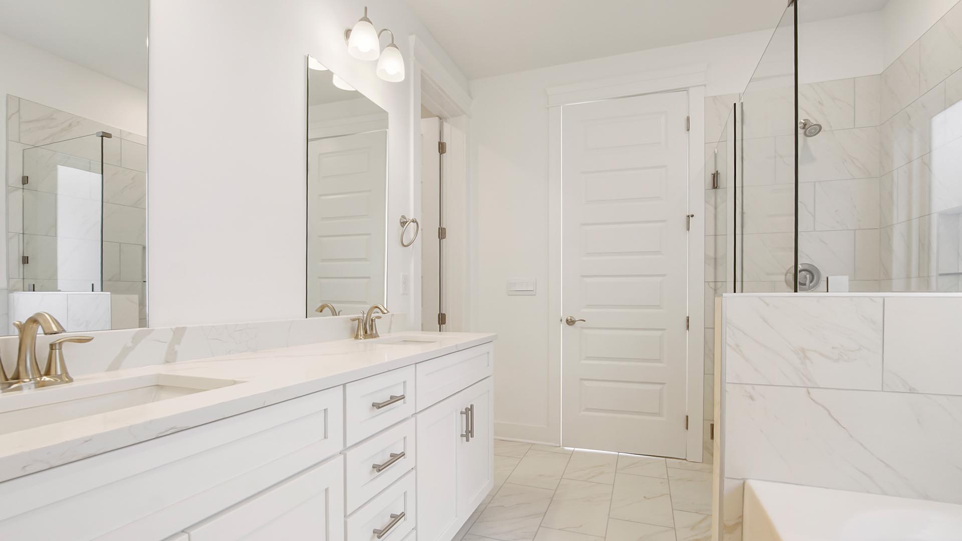 The primary bathroom is elegant and spacious