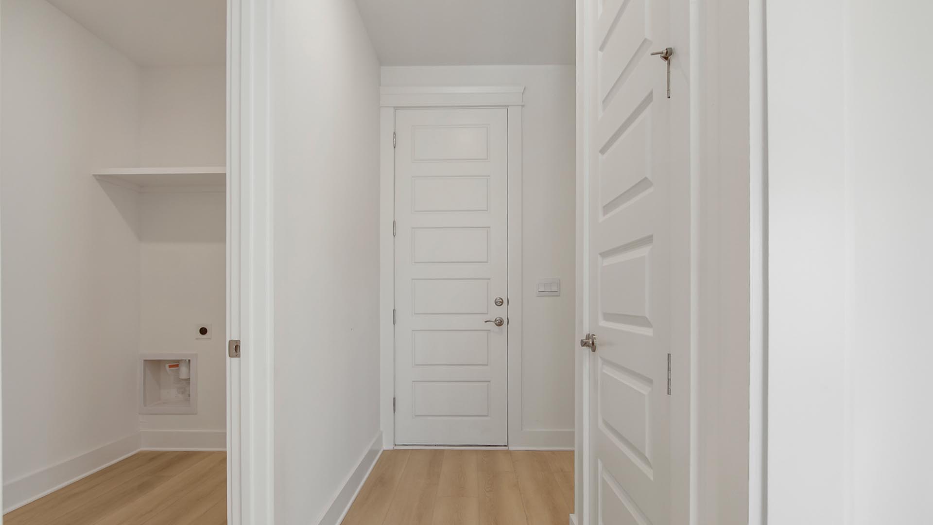 Hall leading to laundry room and garage