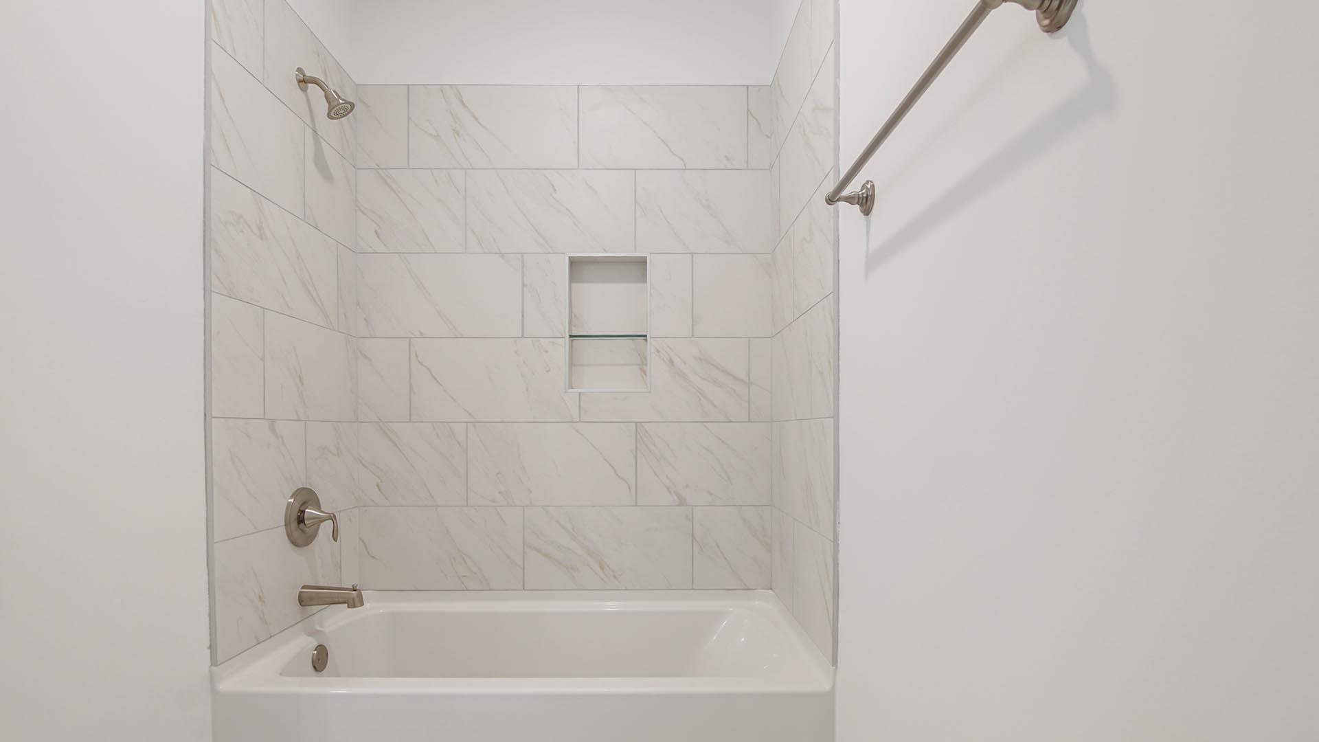 The full bathroom has a shower tub combination